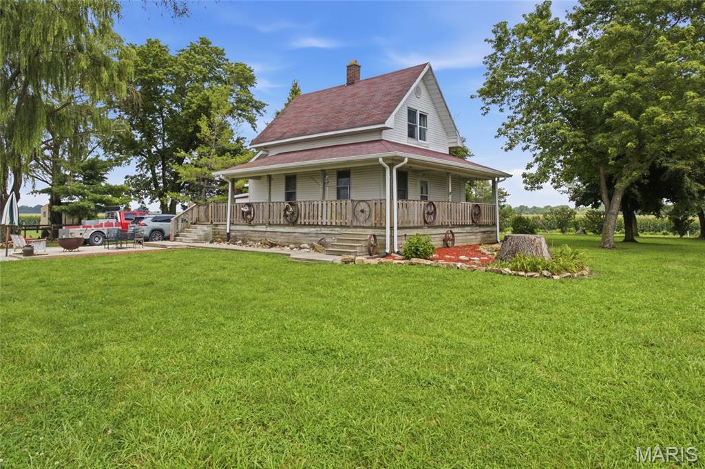 Properties like this are few and far between. Tucked away on 2.5 beautiful acres, this one-of-a-kind country retreat offers the perfect blend of rural charm, modern comfort, and a lifestyle that's becoming harder to find. The inviting 3-bedroom farmhouse is full of character and feels like home the moment you walk through the door. Warm, welcoming, and surrounded by peaceful countryside, it's the kind of place where you can slow down, enjoy the view, and make memories for years to come.

Step outside and you'll discover what makes this property truly special. Designed for horse lovers, hobby farmers, or anyone wanting more space to live, the property features fenced pasture and dry lot areas, a 5-stall horse barn, a chicken coop, dog kennel, garden space, and multiple outbuildings ready for whatever your lifestyle demands.

The entertainment barn is the centerpiece of it all. The spacious loft has been transformed into the ultimate gathering space with a custom bar, pool table, basketball hoop, and plenty of room to host family and friends in every season. Whether you're celebrating holidays, watching the big game, or simply enjoying a weekend together, it's a space that few properties can offer. Afterward, unwind in the dedicated hot tub room and enjoy everything this incredible property has to offer.

Opportunities to own a property that combines a charming farmhouse, usable acreage, equestrian amenities, and an entertainment space like this are incredibly rare. Located just minutes from Highland and Edwardsville with convenient access to St. Louis, this is more than just a home—it's the country lifestyle you've been waiting for.