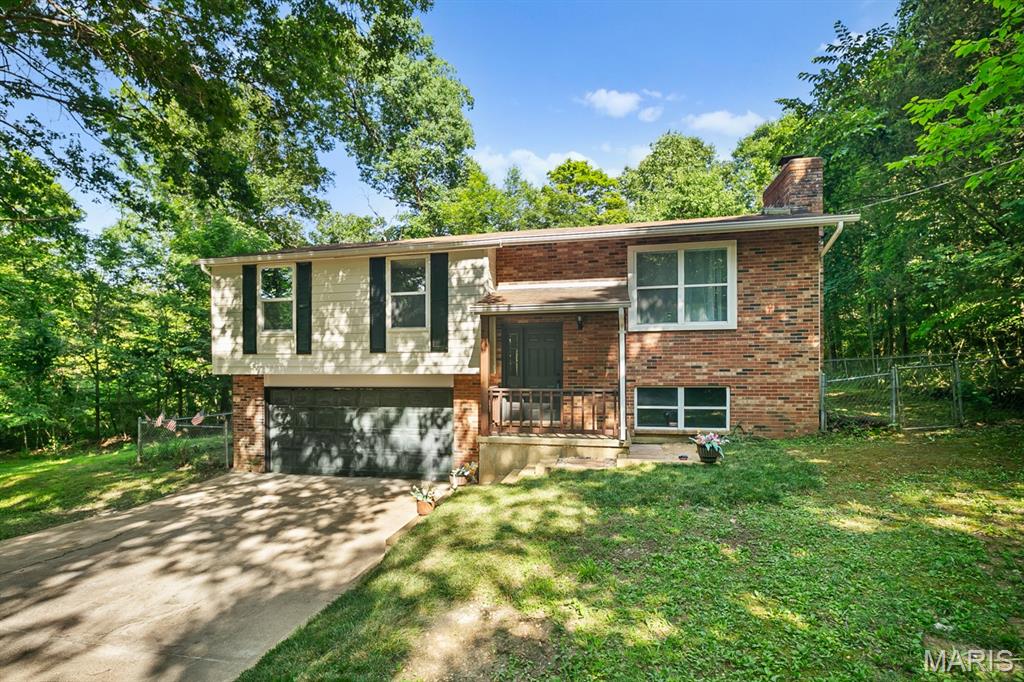 Beautifully remodeled home in the Rockwood School District, but at Jefferson County tax rates!!  Open the French doors from the Master Bedroom,  walk out on the deck and  enjoy breakfast in a natural  setting on 1.1 acres.    On nice days,  open the doors to enjoy the sounds of nature, and after a nice rain, you can hear (and see) a small waterfall on the nearby creek. On cold winter days, light up the fireplace in the cozy Living room, which has a warm feeling  from the engineered wood.    Minutes from Treasured Don Robinson State Park and Labarque Creek Conservation Area,   Glassberg, Young, and LaBarque Creek Conservation Area.  This location combines the quiet solitude of the countryside with the convenience of  top-rated schools. This  home is more than a property- its a retreat.