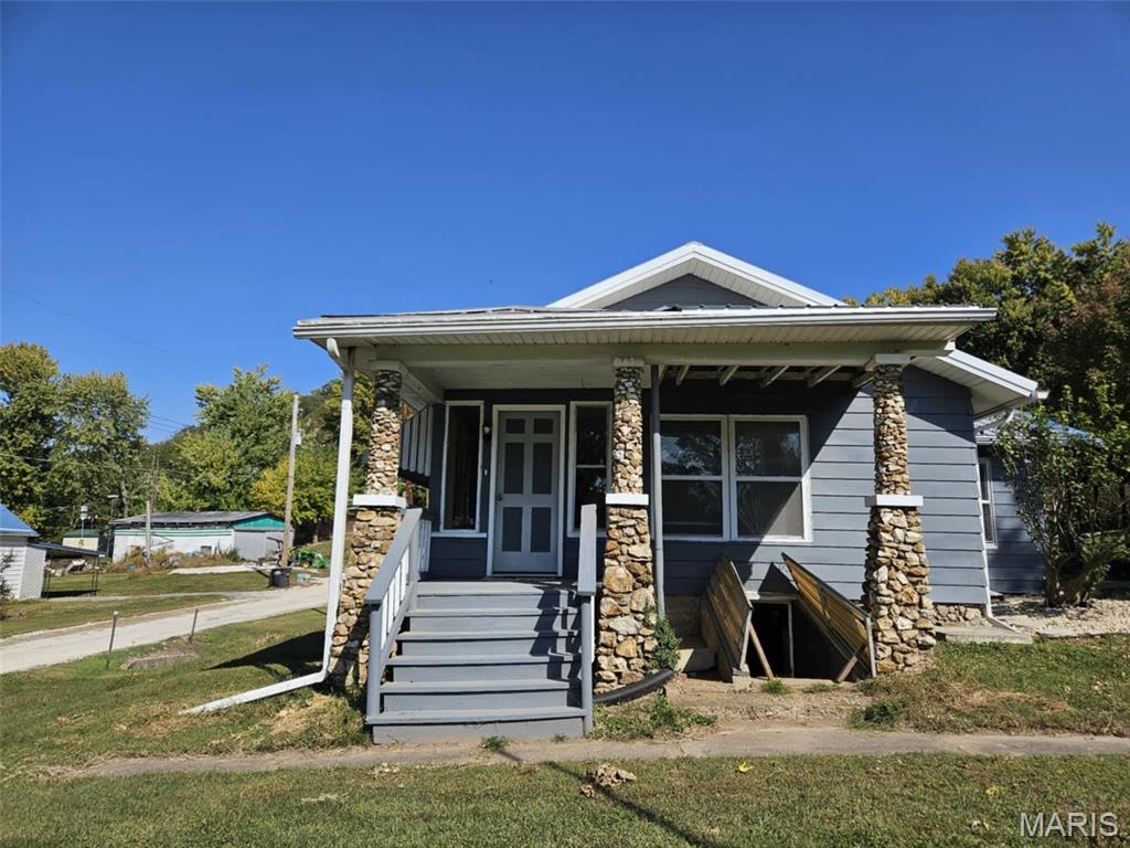 Welcome to this charming 2-bedroom bungalow, perfect as a recreational retreat or full-time home! Situated on 4 spacious lots, this cozy gem offers stunning views of the Mississippi River right from your front yard. Relax in the 3-season sun porch, perfect for enjoying the scenery year-round. For outdoor enthusiasts, there's a boat ramp just down the street, making river adventures easily accessible. The property also features a 30x45 pole barn, complete with water, electricity, and a gas line, ideal for storing your boat or RV. Whether you're seeking a weekend escape or a forever home, this one has it all! This home is NOT located in a flood plain.  PROPERTY IS BEING SOLD "AS IS."