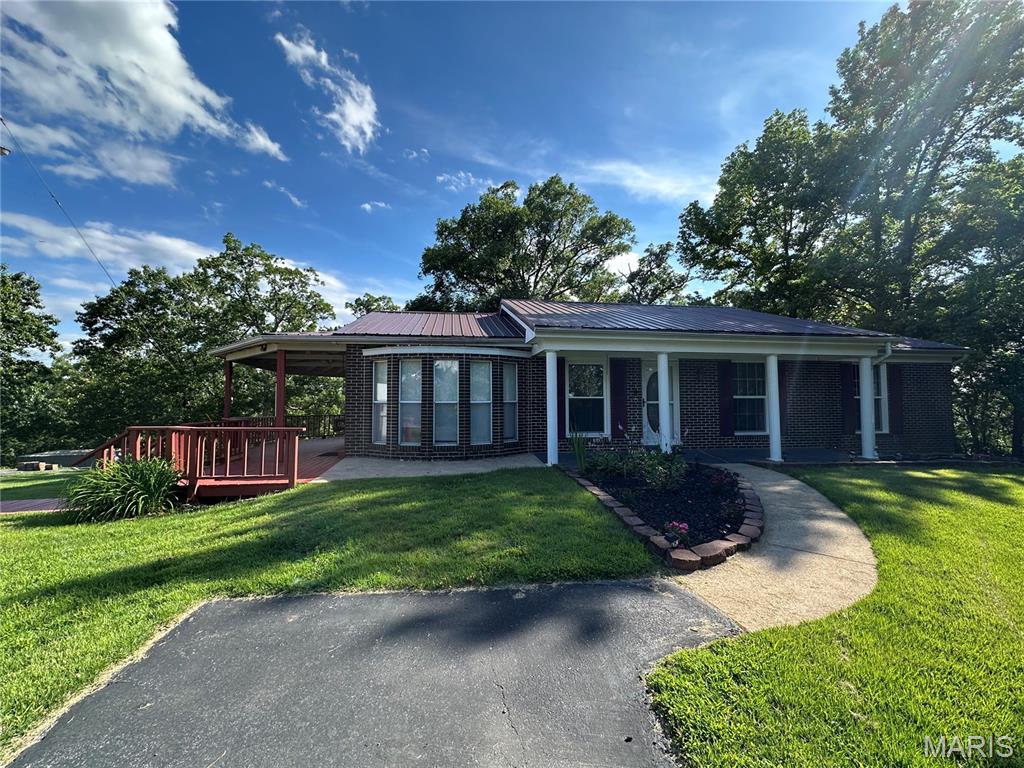 Escape to your own private retreat where comfort, beauty, and modern updates come together seamlessly. Nestled on 3.42 picturesque acres, this beautifully updated 4-bedroom, 2-bath home offers the perfect blend of rural tranquility and contemporary convenience. From the moment you arrive, you’ll be captivated by the breathtaking panoramic views and inviting outdoor living spaces. Enjoy morning coffee or evening sunsets from the expansive wraparound deck, gather around the cozy fire pit, or relax while overlooking the stunning fully stocked 0.33-acre pond complete with an electric aeration system. Inside, you’ll find a thoughtfully remodeled home featuring numerous upgrades, including newer electrical and plumbing systems, a high-efficiency HVAC heat pump, electric fireplace, and a beautifully finished lower level that provides additional living and entertaining space. A whole-home filtration system and water softener add comfort and peace of mind.
Car enthusiasts, hobbyists, and those needing extra storage will appreciate the impressive detached 3-bay garage with its own 200-amp electrical service, along with an additional 2-car carport. The home itself is equipped with a separate 200-amp electrical service, offering ample power for modern living. Nature lovers will delight in the abundance of fruit trees, grapevines, and berry plants scattered throughout the property, creating a truly self-sustaining country oasis. Additional improvements include gutter guards and a professionally installed drainage system designed to direct water away from the home. This exceptional property offers the perfect combination of privacy, functionality, and scenic beauty. Whether you’re seeking a peaceful homestead, hobby farm potential, or simply a place to unwind and enjoy the outdoors, this one-of-a-kind property is sure to impress!