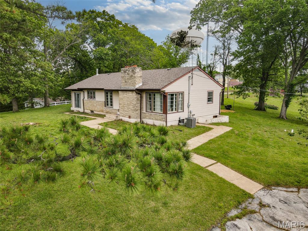 Rare opportunity! 3 bedrooms and 1 bath home with approximately 2.4 acres in the city limits of Herculaneum.  Home features updated kitchen with granite counter tops, separate dining area, wood burning fireplace in the living room and basement, as well as a wood burning stove in the sunroom.  Soffit, gutters and facia have been updated.  There is ample parking with two driveways with access to the home from Well Dr as well as St. Louis St.  Enjoy a large, cleared yard that bumps up to trees and land to explore.  Convenient location with quick access to Hwy 61 and I-55.