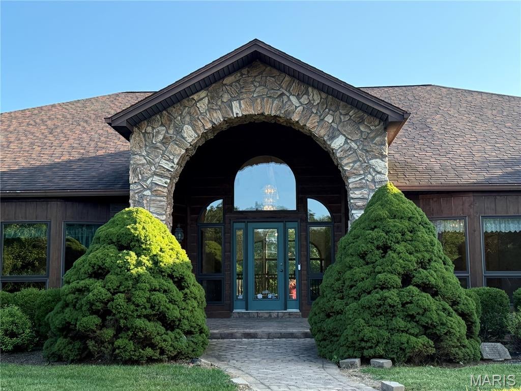 Prepare to be impressed by the remarkable size, character, and possibilities offered by this truly one-of-a-kind estate. Situated on approximately 9.1 acres, this expansive property offers more than 8,000 square feet of living space and approximately 13,000 total square feet, providing an extraordinary amount of room for everyday living, entertaining, hobbies, storage, and more.
The home features six bedrooms and three full bathrooms, along with an impressive collection of living and entertaining spaces. A spacious living room, formal dining room, den, recreation room, sunroom/gardening room, bar area, and loft give this home a versatility that is difficult to find .One of the home’s most memorable spaces is the dramatic room featuring towering windows and beautiful stone architectural details, creating an impressive focal point and allowing natural light to fill the interior. Throughout the property, distinctive architectural elements add character and emphasize the scale of this exceptional residence. The generously sized kitchen provides abundant cabinetry, extensive counter space and a large center island, making it well suited for preparing meals for a household of any size or entertaining a crowd. The bar and recreation areas offer even more space for gathering with family and friends. Upstairs, the unique loft area was previously used as a trophy showroom, offering an incredible space that could be reimagined as a game room, gallery, hobby area, additional lounge, home office or display space.
Storage is another standout feature. With an incredible 17 additional closets, there is room for seasonal items, collections, household necessities and much more — a feature rarely found on this scale. The sunroom/gardening room adds yet another distinctive dimension to the property, providing space for plants, hobbies or simply enjoying the surrounding acreage throughout the seasons. Outside, the home’s expansive setting,  it also  provides privacy, space and beautiful surroundings. Multiple outdoor and deck areas complement the home’s substantial interior and create additional opportunities for relaxing and entertaining. With thee size and flexibility to accommodate a variety of lifestyles and visions. Whether envisioned as an impressive private residence, a multigenerational home, an entertainer’s retreat (Hunting lodge, Camp sight, church camp ect...   or simply a property where everyone can have their own space, this estate presents a rare opportunity. A property of this size, acreage and character simply must be seen in person to fully appreciate everything it has to offer. The 67.9 acre tract listed separately can be sold with this if you are looking for more acreage.