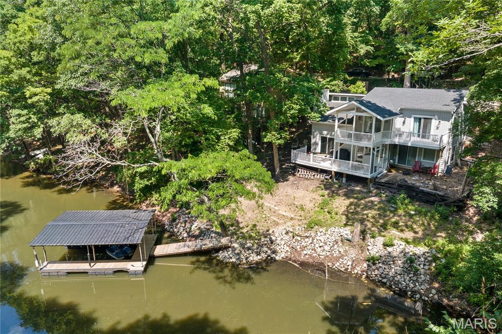 This stunning reverse 2-story lakefront home on MM 3 in Eldon, MO has been completely remodeled in 2024 and is ready for you to move right in! Offering 4 bedrooms, 3 baths, and 1,865 sq ft of beautifully updated living space, this home combines modern luxury with serene lake living. Every detail has been thoughtfully redone—new roof, siding, plumbing, drywall, flooring, paint, light fixtures, and HVAC. The modern kitchen features brand-new cabinets, quartz countertops, a stylish backsplash, and stainless-steel appliances. All bathrooms have been fully renovated with new fixtures, and the decks have been refurbished and stained, including new decking on the 1-well dock. Enjoy vaulted ceilings, abundant natural light, wood floors, and both covered and open decks overlooking the quiet cove teeming with wildlife. Located at the end of a private road with no HOA, this property is ideal as a full-time residence, vacation retreat, or investment opportunity. Conveniently close to Village Marina’s popular bar & grill, tiki bar, pool, and rentals, this lake escape truly has it all—come see it today and start living the lake life!