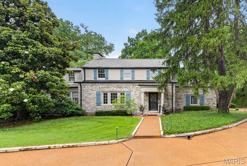 Set on a magnificent acre-plus property in the heart of Ladue, this exceptional stone residence blends timeless architecture with beautifully executed renovations for modern living. Mature trees, sweeping lawns, and thoughtfully curated landscaping create an extraordinary sense of privacy and serenity, while the home’s elegant interiors offer warmth and sophistication.
> At the center of the home is a stunning open kitchen appointed with premium appliances, custom finishes, and built-in breakfast seating, seamlessly connected to the inviting family room for effortless daily living and entertaining. The gracious living room opens to a light-filled sunroom overlooking the stone terrace and expansive gardens, creating a remarkable connection to the surrounding grounds. A substantial, newer mudroom with custom locker storage and an adjoining office add both function and flexibility to the main level. Upstairs, the renovated primary suite is a true retreat, featuring a luxurious, spa-inspired bath and a private terrace. Two additional en-suite bedrooms, including one with an attached workout room or office, are complemented by another spacious bedroom served by a beautifully updated hall bath. The lower level, highlighted by striking stone walls, offers exceptional, flexible space ideal for a media room, playroom, or casual gathering area. An outstanding property in one of Ladue’s most sought-after locations.