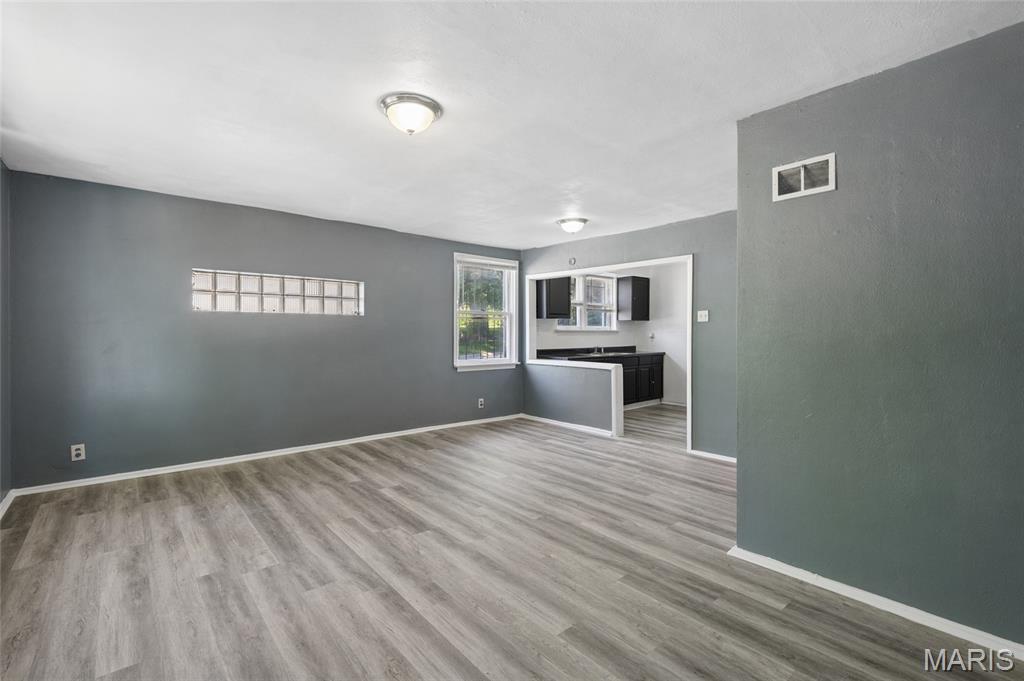 Welcoming Homeowners and Investors- Turnkey property!  837 Wall St. offers approximately 952 square feet of living space with two bedrooms and one and a half bathrooms. The open floor plan creates a spacious and airy atmosphere throughout the residence. The corner lot provides ample space, including a two-car garage and off-street parking. Additionally, the home features two bonus rooms-on each level, offering versatile spaces that can be utilized in a variety of ways to suit individual needs. The unfinished basement provides opportunities for future customization and expansion.  Passed Occupancy, Move in ready.