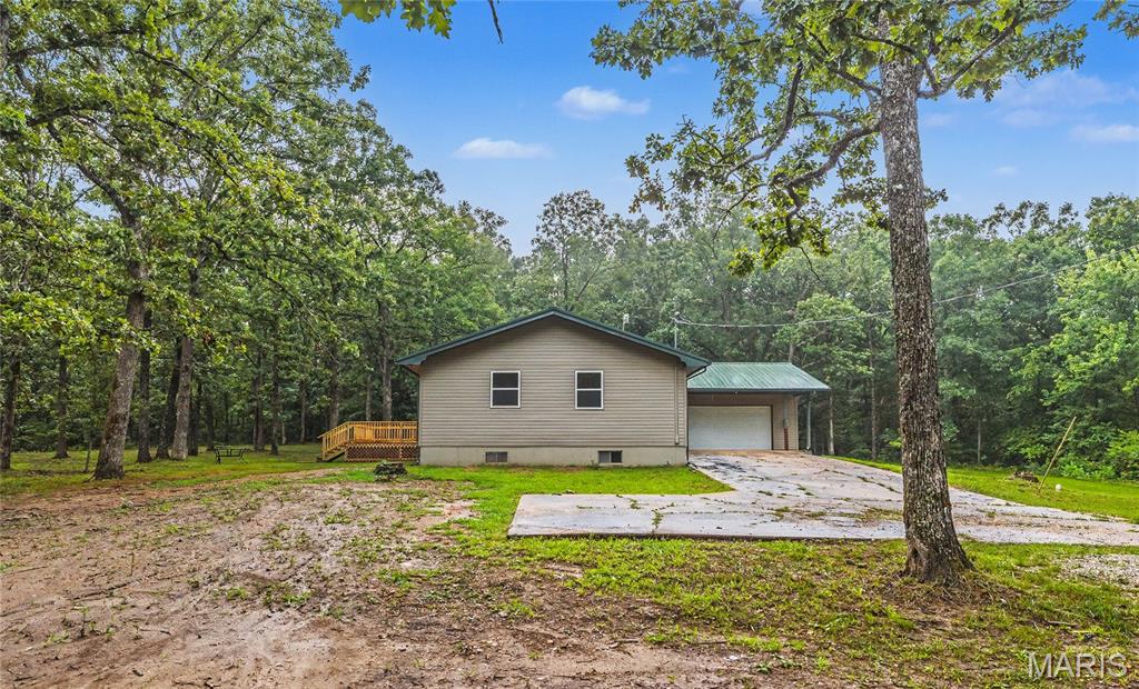 Escape to your own private retreat! Conveniently located just 15 minutes from Rolla and 10 minutes from Salem, this beautifully remodeled home sits in the heart of 20 wooded acres, offering the perfect blend of privacy and convenience. A long, winding driveway leads you to this stunning 3-bedroom, 2-bath home that has been completely renovated from the ground up.

Inside, you'll find an open-concept floor plan featuring a spacious living room, a gorgeous new kitchen, and a main-level primary suite. Every detail has been updated, including new windows, siding, luxury vinyl plank flooring, a brand-new deck, and much more—making this home truly move-in ready.

The full unfinished walk-up basement provides endless possibilities for additional living space while also serving as the perfect storm shelter and storage area. Additional features include a durable metal roof, private well, and attached 2-car garage.

If you've been searching for a secluded property with modern updates and room to roam, this is it. Schedule your private showing today!