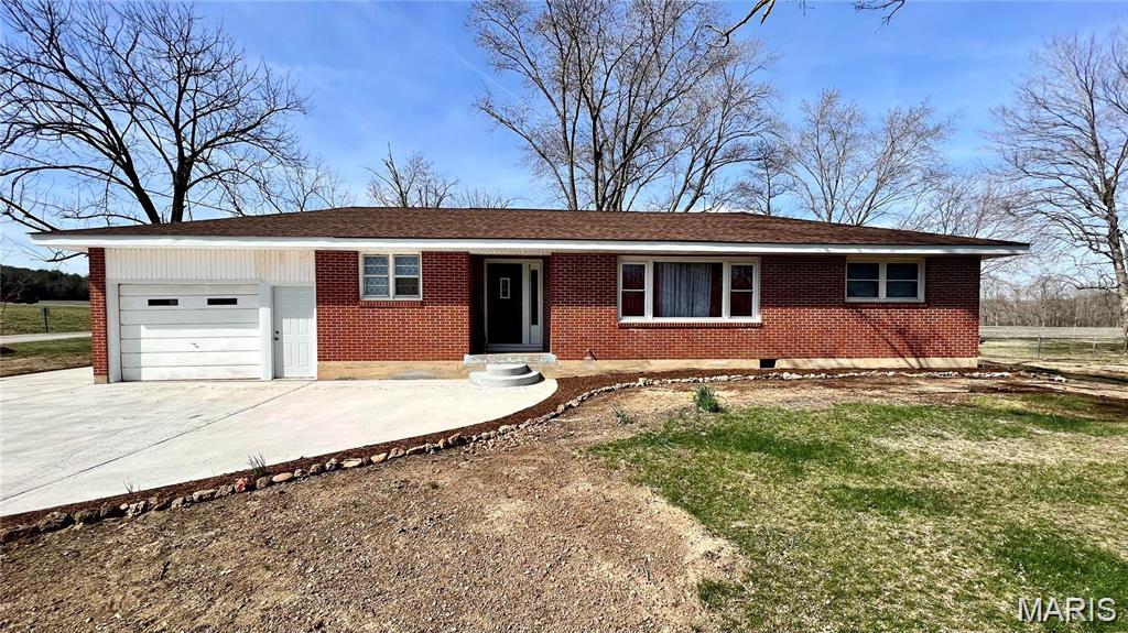 Full Brick Ranch Home with recent upgrades to make it a comfortable living space both inside and out.  Typical of the Mid-Century Modern construction of the late 50's and 60's, everything is on one level for ease and convenience.  The large Kitchen/Dining area is great for entertaining and family meals, while the large, elongated living room is flooded with natural light and spacious walls.  The three bedrooms are perfect for a young family, and the central bathroom facilitates the entire home.  With a nice laundry room off the garage, there's room for hanging racks and additional storage shelves, if desired.  Included in the upgrades you'll note are the kitchen cabinets, roof, central HV/AC, laminate flooring throughout the home, fresh interior paint color, and extensive exterior concrete to replace the driveway apron and sidewalks.  Located just outside of Marquand's city limits, the home puts you within minutes of the new Dollar General, Marquand's small businesses, Marquand-Zion School, the Castor River for fun and recreation, and literally thousands of acres of Mark Twain National Forest!