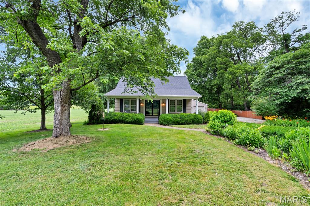 Welcome to this wonderfully unique and character-filled 4 bedroom, 2.5 bathroom home nestled on approximately 1.4 private acres surrounded by peaceful farmland in Dupo! This property offers an incredible combination of space, character, and thoughtful features that are truly hard to replicate.
Step onto the grand 32' x 10' covered front porch and into a home filled with timeless charm and quality craftsmanship. The stunning great room features a wood burning fireplace, beautiful bay window, floor-to-ceiling windows, and elegant crown molding. The front living room also boasts crown molding and large double windows. Six-panel solid wood doors, & original hardwood flooring beneath the carpeting.
The well-appointed kitchen features granite countertops, wood cabinets, hardwood flooring, stainless steel refrigeratorwith in-door ice (Stainless Steel), oven (Stainless Steel), double sink (Stainless Steel), dishwasher, electric self-cleaning slide-in glass cooktop and microwave (all staying with the home)! The beautifully updated main bathroom showcases Kohler fixtures, marble flooring, marble tiled shower walls with glass sliding doors, new sink, marble countertop, and comfort height toilet.
Head upstairs to discover two generously sized bedrooms, each featuring a charming built-in desk perfect for studying, working from home, or creative pursuits. A convenient half bathroom and additional storage space round out the upper level, making it a comfortable and functional retreat for family or guests.
The partially finished basement offers additional finished space, a full porcelain tiled bathroom with walk-in shower, additional electric stove and refrigerator, laundry area with front-loading washer and propane dryer, recreation area, and an electric stair climber for convenient access.
Comfort and efficiency are covered with three zones of warm air heating, two zones of central air conditioning, a whole-house Generac propane generator, updated windows, city water with well water for outdoor use, 1,000-gallon propane tank, aerated septic system, and security system wiring.
Outside, the oversized 27' x 26' detached garage features propane heating, a wood burning stove, attic storage, work bench, and an attached 10' x 26' covered tiled porch. An additional 27' x 30' steel storage shed with electric service - perfect for a home based business, a beautifully landscaped yard with perennial gardens, and a dog pen complete this incredible property.