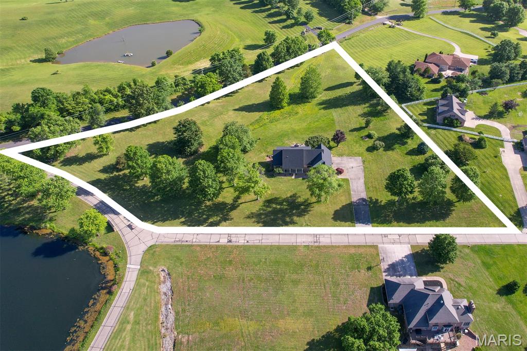 This perfect family urban neighborhood 4.76-acre lot features an all-brick home that offers over 4,000 sq. ft. of living space with 5 bedrooms and 4.5 baths, a main-level master bedroom, including a bonus of a main-level laundry, Custom Cabinets, a pantry with stainless steel appliances, a formal dining, and a living room with a wood-burning fireplace and a built-in cabinet for additional storage. Upstairs features 3 Bedrooms with an abundance of closet space, a Bonus Room or Office area with a Full Bath.  A Finished walkout Basement offers a family room, a full bath with a second kitchen, along with additional space for a family room, a gym, or even a Game Room. Recent home improvements include all the big items: a new roof, gutters, downspouts, HVAC System, landscaping, and a two-car garage with newly installed garage doors.  Enjoy the days with expansive green space and plenty of driveway space for the kids' outdoor activities.  Or simply sitting outside in the evenings, entertaining friends around the outdoor fire pit. Conveniently located between Cape and Jackson, with close access to I-55, but within the desirable Jackson R-2 School District.  Get your country living home now with the convenience of city amenities.