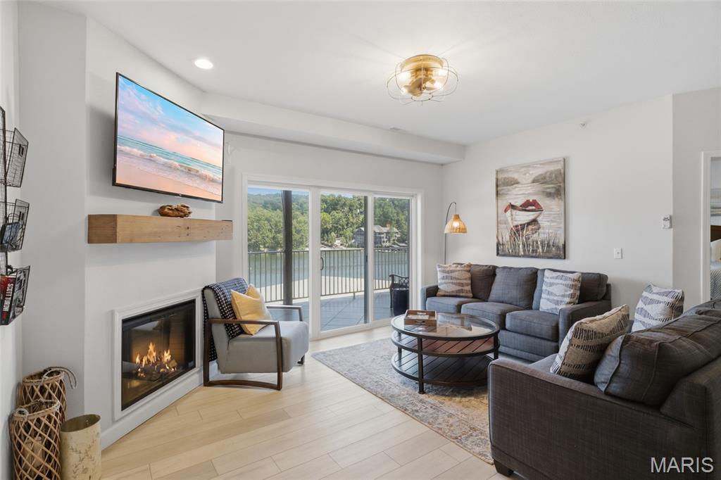 Lake life starts here at Lochhaven! This stylish, updated 3BR/2BA lakefront end-unit condo pairs luxury finishes with the space, views and waterfront setup buyers want at Lake of the Ozarks. Step inside to a bright, open floor plan with wide-plank LVP, custom cabinetry, updated countertops, stainless kitchen appliances and an inviting electric fireplace. Offered turnkey with furnishings, kitchen appliances, washer and dryer included, so you can arrive and start enjoying the lake from day one. The huge tiled deck extends your living space outdoors with water views and room to relax and entertain. Boaters will love the 12x32 slip plus PWC slip with PWC lift included. Nightly rentals are allowed, creating an excellent opportunity for vacation rental income, a second home, or both. Located in a great cove at the 31 MM with easy access to popular lake destinations and excellent water for coving out. This one-level end unit is close to the elevators and offers 1,352 sq ft, 3 bedrooms and 2 full baths. Lochhaven also offers a community pool, boat trailer parking and community docks. Your stylish lake escape is ready—bring your bags and start making memories at Lake of the Ozarks today!!!!