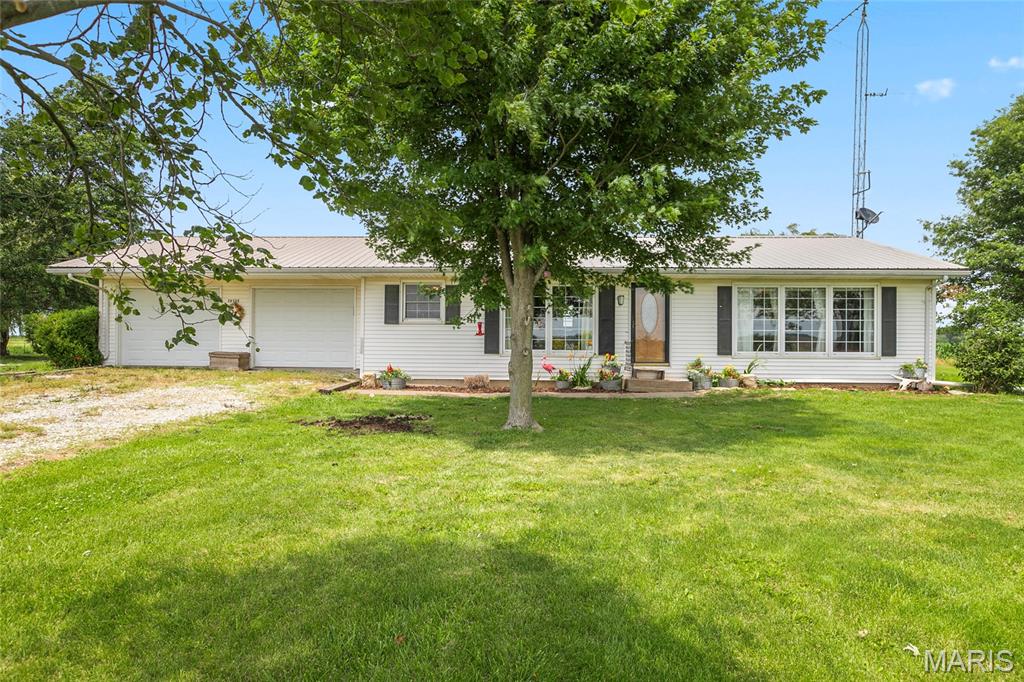 Equestrian dreams meet homestead living on this versatile property in Vandalia, MO—thoughtfully set up for horse enthusiasts, hobby farmers, or anyone craving a self-sufficient country lifestyle.
The charming home offers 2 bedrooms, 1.5 baths, and a functional kitchen/dining combo and bright spacious living room perfect for gathering after a day outdoors. Main floor laundry and an attached 2-car garage and full basement add everyday convenience, making this property as practical as it is inviting.
Step outside and experience the true heart of this property—an impressive 54x96 barn equipped with water and electric, featuring 5 stalls, a tack room, feed room, and grooming stall, ready for daily horse care or expansion of your operation. Enjoy year-round riding in the 50x54 indoor arena, plus a spacious 80x100 outdoor riding area for training, recreation, or hosting gatherings.
The land is well-designed with 2 dry lots and continuous metal fencing, along with 2 fenced pastures for turnout and rotational grazing. Additional improvements include a  grain silo with concrete floor currently used for hay storage (with electric available), carport with shed and animal run, and a chicken coop with electric—perfect for fresh eggs and small-scale farming.
For those dreaming of a mini farm or homestead, this property truly delivers. Established fruit trees including apple, pear, cherry, and peach, along with a productive blackberry patch, offer seasonal harvests right from your backyard. With space for gardens, animals, and sustainable living, this property provides the opportunity to embrace a more intentional, self-sufficient lifestyle.
Whether you’re caring for horses, raising animals, or simply looking to enjoy wide open spaces and country charm, this property offers the flexibility to match your vision. A rare find that combines equestrian functionality with homestead potential—all in a rural setting.