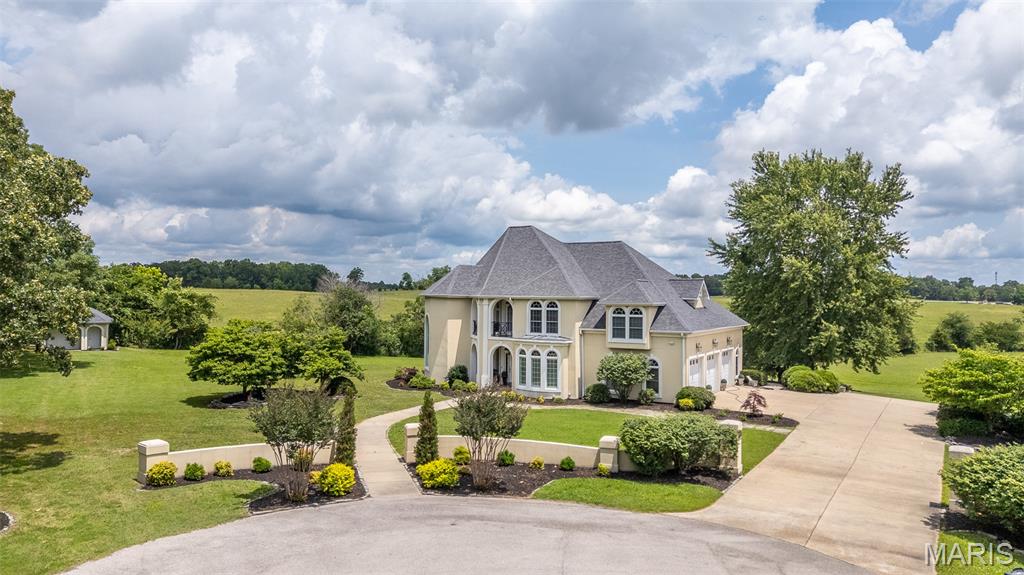 Welcome to one of West Bluff's most distinguished addresses. Nestled on the end of the street in the area's sought after gated community, this remarkable estate offers over 6,100 +/- square feet of refined living space where timeless elegance meets everyday comfort. Perfectly positioned on just over an acre with pond views, this home's soaring ceilings, grand arched openings, and impressive two-story living spaced create an unforgettable first impression. Featuring 6 bedrooms, 5.5 baths, and a full basement, this residence was thoughtfully designed for entertaining and everyday living. The stunning great room showcases dramatic ceiling heights, custom built-ins, rich hardwood flooring, and an abundance of natural light. The spacious kitchen is a chef's dream with extensive custom cabinetry, generous prep space, and seamless flow into multiple gathering areas. Retreat to the luxurious primary suite while family and guests enjoy spacious rooms throughout. The sunroom enclosed patio provide the perfect setting to enjoy morning coffee, evening sunsets, and peaceful pond views year-round. Outside, the landscaped grounds offer privacy, curb appeal, and an exceptional backdrop for outdoor living! A rare opportunity to own a truly exceptional luxury estate in West Bluff! Location is everything! You want to see this one.