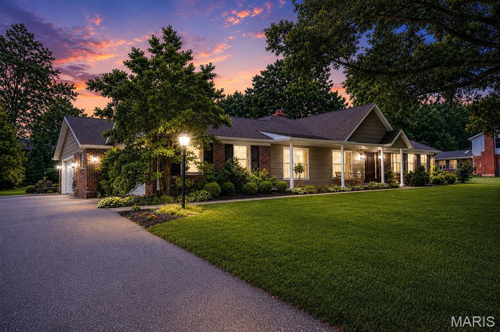 Looking for the perfect ranch home in Kirkwood Schools? Whether you're raising a family or seeking an elegant age-in-place sanctuary, this exceptional home offers the perfect blend of beauty, comfort, and functionality. Thoughtfully transformed by the current owners, the home was expanded by more than 1,500 square feet and includes an additional two-car garage, creating the spacious and versatile floor plan you see today.

From the moment you arrive, the expansive front porch and stunning mahogany front door set the tone. Inside, gleaming hardwood floors, an oversized dining room with crown molding, wainscoting and  custom designer lighting create an inviting first impression. Every detail of this home was thoughtfully crafted by the current owners, including custom cabinetry and finishes throughout.

The heart of the home is the spectacular kitchen featuring handcrafted cabinetry, custom glazing, granite countertops, heated porcelain floors (running between the back kitchen wall and the island), a large center island with seating for four, convection ovens, a gas cooktop, and a stainless steel refrigerator. The adjoining breakfast room and expansive family room with a gas fireplace open seamlessly to the screened porch overlooking the private backyard—an ideal space for relaxing or entertaining.

A cozy hearth room with a wood-burning fireplace provides an additional gathering space just off the kitchen. The thoughtfully designed floor plan also includes a spacious laundry room, beautiful powder room, and direct access to the oversized four-car garage configuration with ample driveway parking.

The private bedroom wing features a generous primary suite with custom crown molding, multiple closets, including a walk-in closet and dedicated "She Closet". The luxurious ensuite bath offers custom finishes and heated marble floors for year-round comfort. Two additional bedrooms and a beautifully updated hall bath complete the main level.

The finished lower level expands your living space with new luxury vinyl flooring, a full bathroom, and a brand-new radon mitigation system. With abundant square footage and flexible layout options, the lower level is perfect for recreation, entertaining, a home office, gym, or additional bedrooms.

This is a rare opportunity to own a meticulously maintained, custom-designed ranch home offering exceptional living space, thoughtful updates, and timeless appeal in the highly sought-after Kirkwood School District.

Welcome Home!