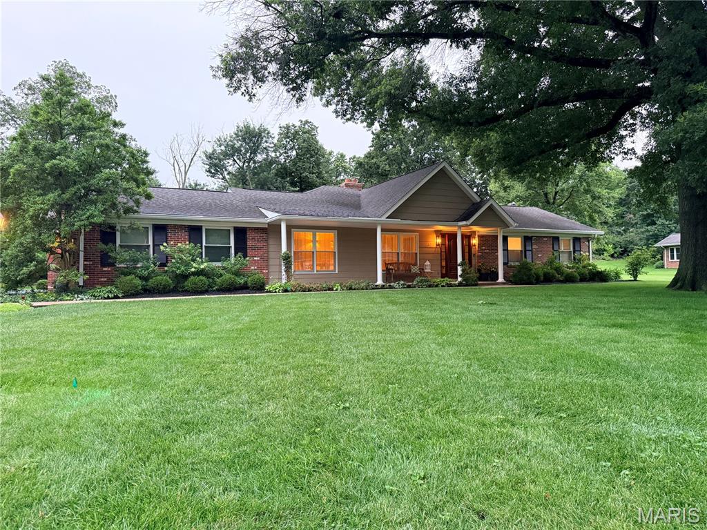 Looking for the perfect ranch home in Kirkwood Schools? Whether you're raising a family or seeking an elegant age-in-place sanctuary, this exceptional home offers the perfect blend of beauty, comfort, and functionality. Thoughtfully transformed by the current owners, the home was expanded by more than 1,500 square feet and includes an additional two-car garage, creating the spacious and versatile floor plan you see today.

From the moment you arrive, the expansive front porch and stunning mahogany front door set the tone. Inside, gleaming hardwood floors, an oversized dining room with crown molding, wainscoting and  custom designer lighting create an inviting first impression. Every detail of this home was thoughtfully crafted by the current owners, including custom cabinetry and finishes throughout.

The heart of the home is the spectacular kitchen featuring handcrafted cabinetry, custom glazing, granite countertops, heated porcelain floors (running between the back kitchen wall and the island), a large center island with seating for four, convection ovens, a gas cooktop, and a stainless steel refrigerator. The adjoining breakfast room and expansive family room with a gas fireplace open seamlessly to the screened porch overlooking the private backyard—an ideal space for relaxing or entertaining.

A cozy hearth room with a wood-burning fireplace provides an additional gathering space just off the kitchen. The thoughtfully designed floor plan also includes a spacious laundry room, beautiful powder room, and direct access to the oversized four-car garage configuration with ample driveway parking.

The private bedroom wing features a generous primary suite with custom crown molding, multiple closets, including a walk-in closet and dedicated "She Closet". The luxurious ensuite bath offers custom finishes and heated marble floors for year-round comfort. Two additional bedrooms and a beautifully updated hall bath complete the main level.

The finished lower level expands your living space with new luxury vinyl flooring, a full bathroom, and a brand-new radon mitigation system. With abundant square footage and flexible layout options, the lower level is perfect for recreation, entertaining, a home office, gym, or additional bedrooms.

This is a rare opportunity to own a meticulously maintained, custom-designed ranch home offering exceptional living space, thoughtful updates, and timeless appeal in the highly sought-after Kirkwood School District.

Welcome Home!