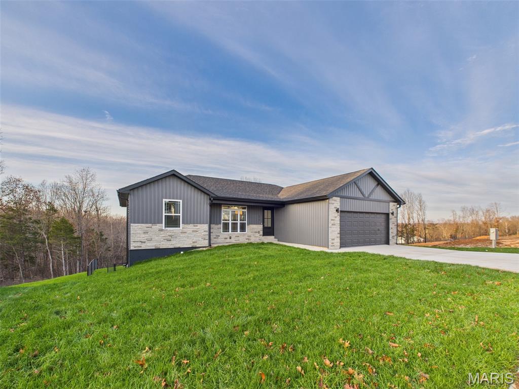 SELLER IS OFFERING UP TO $5,000 IN BUYER INCENTIVES! Use this GENEROUS CREDIT toward buyer's closing costs, a purchase price reduction, interest rate buy-down, or additional upgrades—flexibility that adds real value and makes this exceptional home even more attainable.

Welcome to refined Ozark living in this beautifully crafted, turnkey custom four-bedroom, three-bath home, thoughtfully positioned on a premium .56 m/l acre lot in the highly desirable Summit Pass Subdivision. Backing to mature trees and extensive untouched natural land, this property offers a rare sense of peace, privacy, and connection to nature—all while remaining conveniently close to town amenities. The chain-link fenced rear yard enhances both functionality and security, making it ideal for pets, safe play, or simply enjoying your own private outdoor retreat.

From the moment you arrive, the home’s curb appeal and intentional design stand out. A welcoming covered front porch invites you inside, while accessibility-focused planning and energy-efficient construction provide comfort and long-term savings. Step into the open-concept main level where vaulted ceilings, expansive sightlines, and abundant natural light create an atmosphere that is both warm and sophisticated. Every detail has been selected to balance everyday livability with elevated style.

The gourmet kitchen is truly the heart of the home, designed to impress chefs and entertainers alike. It features custom soft-close cabinetry, gleaming granite countertops, stainless steel appliances, and a large center island perfect for meal prep, casual dining, or gathering with guests. Flowing seamlessly into the dining and living areas, this space is ideal for hosting while still feeling cozy and inviting.

The luxurious primary suite serves as a private sanctuary, highlighted by a coffered ceiling, spacious walk-in closet, and spa-inspired ensuite bath. Enjoy dual granite vanities, sleek anti-fog LED mirrors, and a stunning custom-tiled walk-in shower that elevates daily routines into moments of relaxation. The main level also includes an additional bedroom with ample closet space and a full guest bath featuring a granite vanity and touch-activated LED anti-fog mirror— these two rooms are perfect for guests or a convenient home office setup.

Outdoor living is equally impressive. The covered rear deck, conveniently located off the main living area and kitchen, offers the perfect setting for entertaining or unwinding after a long day. Whether you’re enjoying morning coffee, evening sunsets, or watching deer and wild turkey roam through the surrounding Ozark hills, this space delivers year-round enjoyment.

Downstairs, the walk-out basement expands your living options even further. It includes two additional bedrooms, a spacious family or recreation area, a full bath, and an unfinished space ideal for storage, a workshop, or future customization. This flexible layout accommodates multi-generational living, guests, or growing household needs with ease.

No detail was overlooked in the construction and upgrades of this home. Features include durable LVP flooring, 30-year architectural shingles, spray foam insulation, energy-efficient windows, a Carrier heat pump, and a fully insulated two-car garage—all contributing to comfort, efficiency, and peace of mind. Adding even more value, the home comes with a 1-year limited builder’s warranty, offering confidence in quality and craftsmanship.

This property delivers an exceptional combination of modern design, thoughtful functionality, and serene surroundings—plus a seller incentive that truly sets it apart. Opportunities like this in the Summit Pass Subdivision do not last long. Schedule your private showing today and experience firsthand everything this remarkable home has to offer.