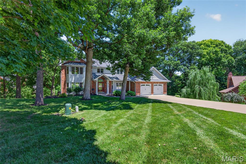 The opportunity has finally arrived to own this amazing 6 bedroom, 4 bath home on a beautiful private 1 ACRE wooded lot nestled inside of a cul-de-sac in the heart of St. Charles.  Abundance awaits your arrival, step inside the spacious 2 story entry foyer with ceramic tile flooring, split staircase, wood floors throughout the main floor, vaulted kitchen with skylights, stainless steel appliances with Thermador gas cooktop, solid surface countertops, spacious walk-in pantry, planning desk, separate dining room with plantation shutters.  Head upstairs to find the vaulted primary suite with bay window, large walk in closet, bright ensuite bathroom with vaulted ceiling, skylights, double sink vanity and separate soaking tub and shower.  There is tons of space for everyone, with 4 more additional bedrooms down the hall with and a Jack n Jill style bathroom.  The living space is extended into the finished walk-out basement with cozy wood burning stove, lots of extra storage space, full bathroom and extra 6th bedroom.  There are high quality touches throughout, including Anderson windows, a central vac system, huge newer composite deck with 3 access points to enter home, giant laundry room/mud room combo, 9' ceilings, brick surround fireplace with gas log insert, new upper level a/c furnace, newer hot water heaters, and an Oversized Garage with 2 separate taller doors to fit your larger vehicles.  Make an appointment to see it today!