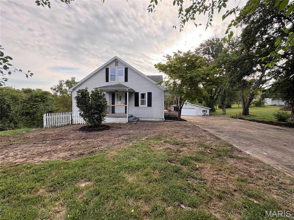 Get out of town! Literally. This 3 bed 3 bath country home is nearly in town but just outside the city limits. 2.18+/- acres of private land, no subdivision, no HOA. Inside, you'll find some original hardwood floors and a kitchen that has been completely redone along with the separate dining room/den just off the back of the kitchen. There are 2 bedrooms on the main floor separated by an updated full bath. You'll find a large bedroom upstairs with lots of little nook and cranny spaces for storage, also a nice size full bath that has an antique cast iron claw foot soaking tub. Not only that but there's a full walkout basement with the option to make an egress window for a possible 4th bedroom. Looking for a large deck to enjoy? Get an eye on this one. Hoping to have a place for that hot tub? There's a concrete patio by the basement door with the wiring already in place. Need some additional storage or garage space? An oversized detached garage is waiting for you with its own furnace for heating and separate workspace ideal for storage, creativity and tackling tough jobs. The garage will need some work to bring back to its glory days but it even has a chain link fenced in area on the back that could be for chickens or a dog kennel and run. With a little love and restoration, you can also bring back to life the old barn, maybe enjoy having a hobby farm by prepping it for animals or just have a nostalgic, rustic hang out near the old water garden. New roofs are scheduled to go on the home, garage and barn! Don't miss out on a rare opportunity to find a home in the country right next to town!