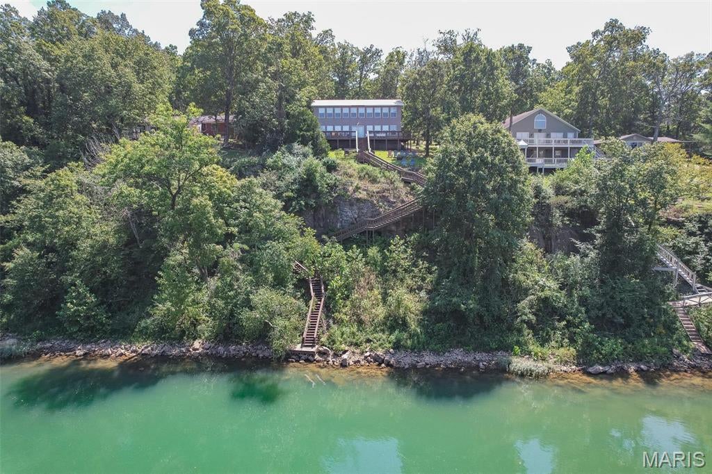 Stunning Riverfront Retreat in Doniphan!

Welcome to your dream riverfront home in the Current River Estates community. This spacious 4-bedroom, 3-bathroom home offers 2,500+ square feet of living space, perfect for year-round living or keep it as a profitable vacation rental. Nestled along the beautiful Current River close to town (3 minutes), this property boasts breathtaking views and provides private, gated access to the river for the handful of people that have homes here. The expansive back deck is a true highlight, extending down to the river's edge. Enjoy the serene views while relaxing in your private hot tub. Inside, the home features an open-concept living and dining area, ideal for entertaining or enjoying family gatherings. With the option to purchase fully furnished, this home is move-in ready or a turnkey investment opportunity. It’s the top performer for the area on Airbnb with over 160 glowing reviews on Airbnb alone, ensuring a strong rental history. Selling turn key fully furnished as you see it today!
