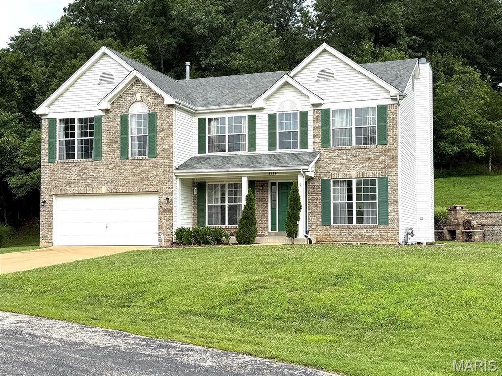 Stunning 4-Bedroom Golf Course Home at 4943 Country Club Drive, High Ridge, MO 63049.  Welcome home to this meticulously maintained 2-story gem, perfectly positioned along the 16th fairway of Sugar Creek Golf Course in desirable High Ridge!  Built in 2003, this spacious 2,912 sq ft residence sits on a generous 0.92-acre lot and offers the perfect blend of elegance, comfort, and outdoor lifestyle.   Step inside to an inviting open-concept main level featuring hardwood floors that flow seamlessly throughout.  The formal dining area is ideal for hosting gatherings, while a front office provides a convenient spot for getting work done.  The heart of the home is the expansive family room, highlighted by a cozy brick wood-burning fireplace and large window views of the landscaped yard.  The upgraded kitchen features granite countertops, 42" cabinetry, a large center island with seating, and stainless steel appliances.  Upstairs, discover a massive loft area ideal for hobbies, a playroom, or second family room retreat. The enormous primary suite boasts incredible closet space and a luxurious private bath. Three additional generously sized bedrooms, each with walk-in closets, provide ample room for family or guests.  Outside, the expansive .92-acre yard backs to a peaceful tree line, creating a private oasis perfect for unwinding after a round of golf or enjoying Missouri evenings. Located in a golf-centric community near Fenton, this property provides easy access to West County, South County, shopping, dining, and top amenities.  Sugar Creek Golf Course offers scenic rolling hills, a public course with strong local reputation, and a welcoming atmosphere for enthusiasts.