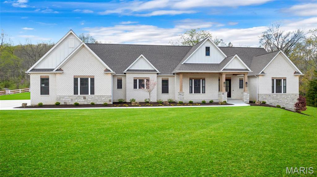 Experience luxury living in this new, custom-built home situated on 8.27 private and picturesque acres. This expansive modern ranch offers over 7,200 sq. ft. of open living space with 10' ceilings, vaulted details, exposed wood beams, and stunning white oak flooring. Nearly every room features custom cabinetry, built-ins, and designer finishes.

The gourmet kitchen is an entertainer’s dream, complete with high-end appliances, a spacious island, and a separate prep/butler’s kitchen. All five bedrooms include en-suite baths, and the primary suite showcases a spa-inspired bathroom and oversized walk-in closets.

Enjoy year-round indoor/outdoor living on the large screened-in patio featuring infrared heaters and a wood-burning fireplace. The finished lower level offers full secondary living quarters with a kitchenette, two recreation areas, a theatre room with raised seating, Sonos whole-home audio, a generous fitness room, and two additional bedrooms with en-suite baths.