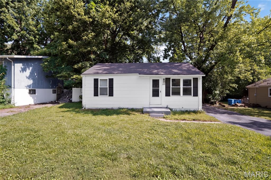 Charming ranch-style home offering comfortable single-level living with a partially finished basement for added flexibility. This 2-bedroom, 1-bath residence features wood flooring, abundant natural light, and a functional layout designed for everyday living. The spacious backyard is fenced, providing room for outdoor enjoyment, pets, or gardening. Off-street parking, public utilities, and a convenient location near schools, shopping, parks, and major roadways add to the home's appeal.