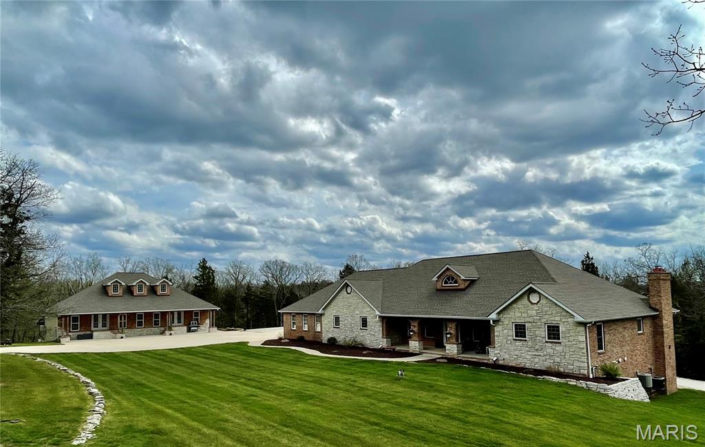 Here it is all you brick and stone lovers!!  This beautifully built and well constructed home is ready for you!  This 3,000 plus sq ft home has 4 bedrooms, 3 baths, large rooms, chef's dream kitchen with stainless steel appliances, lots of cabinets, so much counter space and a massive pantry!!  The home also has an open floor plan, beautiful entry foyer, 2 woodburning fireplaces, incredible primary bedroom, bathroom and walk in closet, main floor laundry, full basement, new huge deck and so much more!!  But, just wait til you walk out to the shop!!  It is 60 x 40 and constructed with brick and stone, to match the house!!  It has a 60 x 36 lean to, has heat and a/c, 200 amp service, dual overhead bridge crane system, 10,000 pound car lift, mechanical room, bathroom, 24 ft work bench, mezanine, and the list goes on!!  Additional 40 x 15 storage shed with concrete floor.  Automatic hard wired custom access gate with lights.  The park like sod yard has an irrigation system for yard and flower beds.  This all sits   in on two lots totaling over 10 acres in the Union School District.  Don't come and look at this one unless you're prepared to fall in love!!