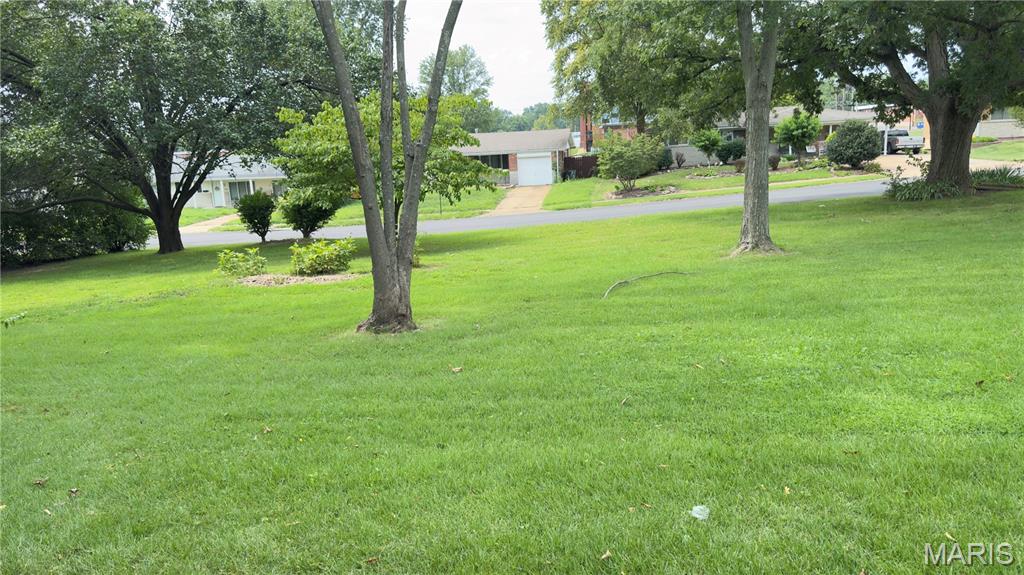Looking for the perfect spot to build your next home? This corner lot in Florissant is an exceptional opportunity. Situated at Herbst & Jenkee, the property offers generous dimensions of approximately 123x87 feet, giving you plenty of room for a comfortable home, yard space, and flexible driveway placement.

The neighborhood is filled with well-kept brick ranches from the 1960s, offering a charming, established feel with mature trees and consistent curb appeal. Unlike buying in a brand-new subdivision, here you’ll enjoy the benefits of building in a quiet, stable community where homes have character and neighbors have roots.

Florissant itself is one of St. Louis County’s most historic and livable cities, blending small-town friendliness with big-city convenience. You’ll be close to parks, schools, shopping, dining, and major highways — with downtown St. Louis less than 25 minutes away.

Whether you’re a builder, investor, or homeowner dreaming of new construction, this rare buildable lot offers the best of both worlds: new beginnings in a classic Florissant neighborhood.