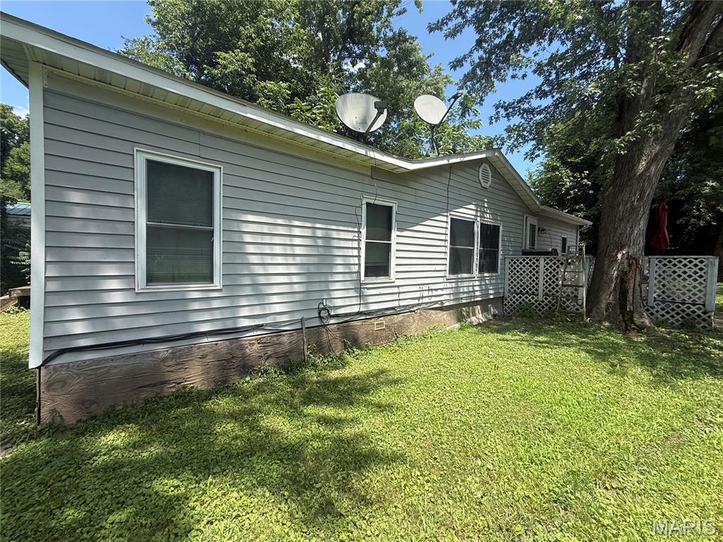 Three bedroom and two bathroom manufactured home on level lot. The home sits on a flat yard that is fenced in and can be accessed from either side. There is a carport for covered parking off O'Fallon Street alley. The home has an open floor plan with living room, dining room, and kitchen. Kitchen has wood cabinets and all appliances, including washer and dryer, can convey. The home has a split bedroom layout with the main bedroom and bathroom on one side and the two additional bedrooms and bathroom on the other.