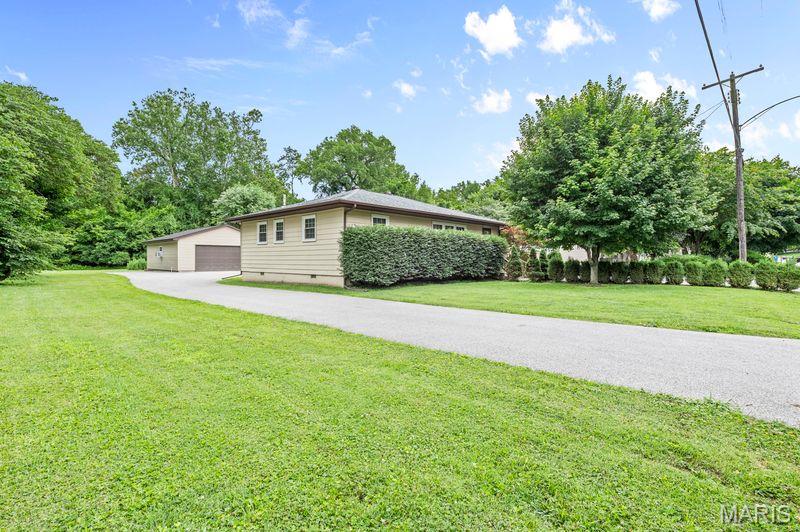 Located on over half an acre, this charming Caseyville home is ready for new owners! With a large living room space perfect for relaxing or entertaining, this two bed, one bath home also offers a diverse bonus room/office/third bedroom (currently used as a laundry/mud room).  Step outside and enjoy the large, quiet back yard with plenty of room for outdoor activities, gardening, or gatherings. A detached 2 car garage offers loads of storage and workspace, while the expansive wrap around driveway offers ample parking. Conveniently located with easy access to local amenities, this property combines comfort, functionality, and outdoor space in one affordable package.