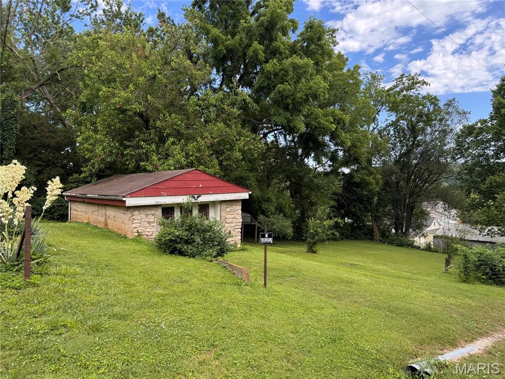 How will you use this 0.165 corner city lot with charming stone garage/workshop/storage, several fruit trees, raspberry bushes. and grape vines?
Home site or a hobby spot? Love the appeal of the stone structure and green space!  Check it out today!