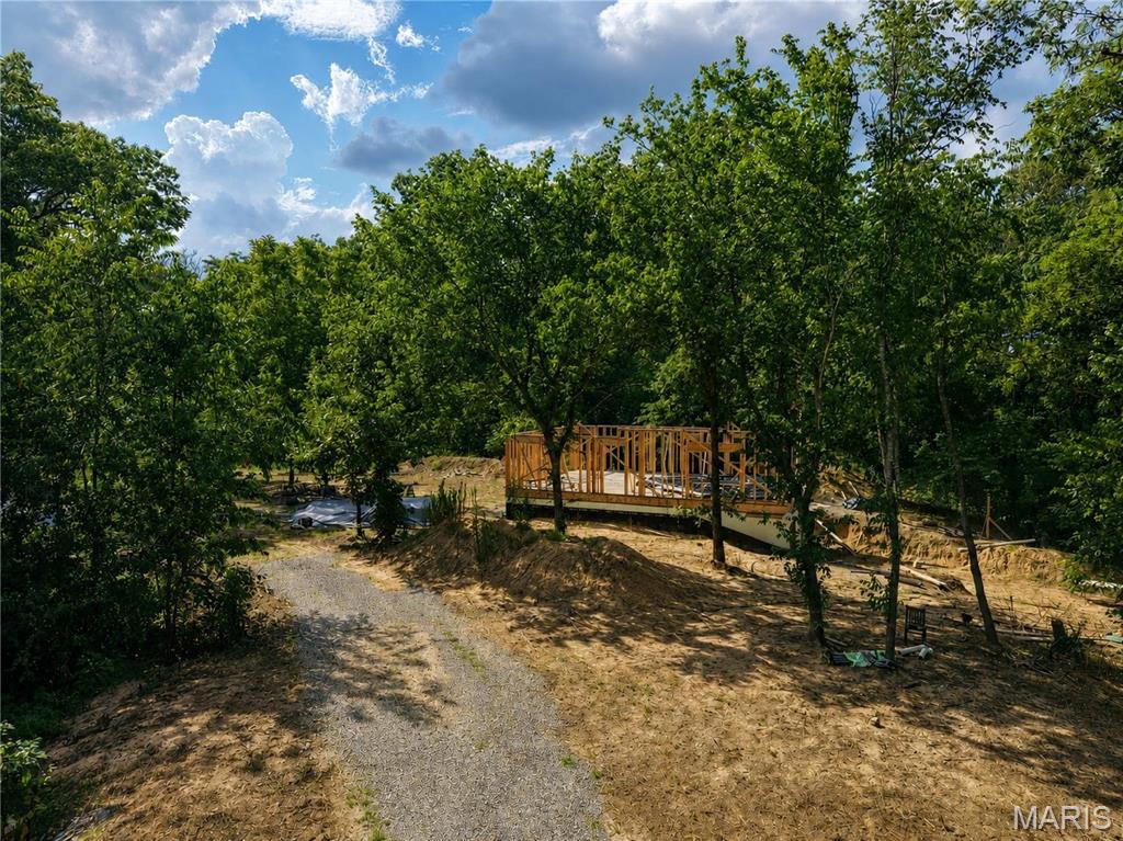 Looking for a place to build, hunt, or just get away? This 12.32 +/- acre property offers plenty of possibilities. Mostly wooded and tucked away in a rural setting, it's a great spot for hunting, riding trails, or enjoying the outdoors. A poured basement is already in place giving you a head start if you're looking to build a home. The property also features RV hookups along with new water, electric, and Septic already installed, making it easy to enjoy the property while you build or use it as a weekend retreat. Whether you're ready to finish the home that's been started or simply want a great recreational property with utilities already in place, this one is worth a look.