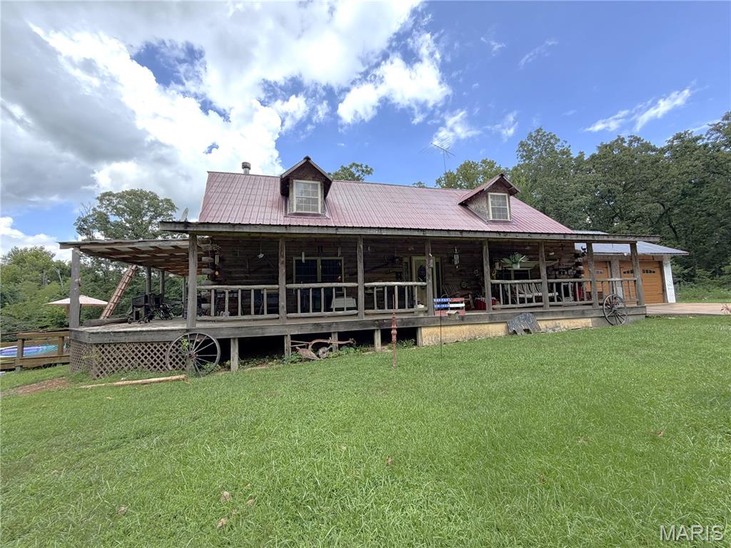 Private Log Home Retreat on 8 Acres with Income Potential!!
Escape to the peace and privacy of this beautiful 3-bedroom, 2-bath log home nestled on 8 scenic acres. From the moment you step inside, you'll appreciate the exceptional craftsmanship, featuring stunning tongue-and-groove walls and ceilings, exposed wood beams in the living room and dining area, and warm natural woodwork throughout.
The spacious home includes a full unfinished walk-out basement with radiant floor heat, offering endless possibilities for additional living space, a workshop, or storage. There is an outside wood furnace.  Step outside to enjoy the expansive front yard or relax on the inviting wraparound porch that stretches across the front of the home and continues along the side to the above-ground pool—perfect for entertaining or simply taking in the peaceful surroundings.
This versatile property offers incredible bonus features, including a 14' x 50' single-wide mobile home that is currently rented, providing immediate rental income. An additional in-law suite, currently operating as a beauty shop, offers flexible space for extended family, a home business, or additional rental opportunities.
Outside, you'll find a large barn with fencing, making the property ideal for hobby farming, livestock, horses, or equipment storage. The beautifully landscaped yard enhances the home's curb appeal while maintaining the privacy and tranquility of this country setting.
Whether you're looking for a family home, a mini-farm, or a property with multiple income opportunities, this one-of-a-kind retreat has it all!
Owners are selling the property As Is.