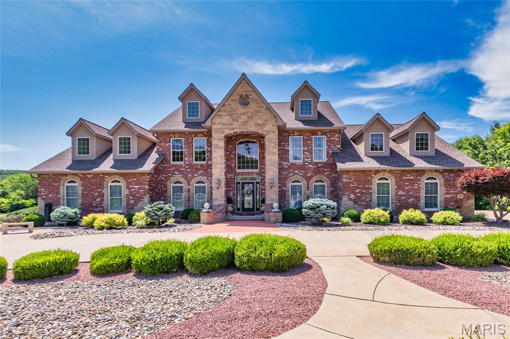 Luxury Estate on 11.39 Private Acres | 8,000 Sq Ft approximately | Pool | Guest Quarters | 3,600 Sq Ft Detached Garage.  Welcome to this extraordinary custom-built estate nestled on 11.39 secluded acres in the heart of Festus. Overlooking a beautiful stocked pond, this one-of-a-kind property offers 8,000 square feet of thoughtfully designed living space, combining luxury, comfort, and functionality. Featuring 7 bedrooms, 8 full bathrooms, and 1 half bath, the home showcases impressive 20-foot ceilings entry, rich wood flooring, and expansive living areas designed for both everyday living and large-scale entertaining. The chef’s kitchen is a true centerpiece, equipped with quartz countertops, dual refrigerators, dual sinks, and dual dishwashers, dual cooktops, dual ovens, providing exceptional space and convenience for hosting family and guests. The stunning 956-square-foot primary suite serves as a private retreat, complete with vaulted ceilings, three closets, and a dedicated laundry room. The main level also includes a guest bedroom and full bath, while the upper level features a spacious loft and three bedrooms, each with its own private en-suite bathroom. The finished lower level offers additional living and entertaining space, including a large family room and a complete in-law suite with private garage access. Property Highlights:  8,000 Sq Ft Custom Home - 11.39 Private Acres with Stocked Pond Views - 7 Bedrooms | 8 Full Baths | 1 Half Bath - 474 Sq Ft Sunroom - 36,000-Gallon Heated In-Ground Pool & Hot Tub - 3,600 Sq Ft Climate-Controlled Detached Garage with RV storage and car lift - Separate Secondary Building with living quarters, garage, and private entrance - Multiple Garage Spaces (12) for vehicles, recreational equipment, and workshop needs - Ideal for Multi-Generational Living, Entertaining, or Hobby Enthusiasts.  From the resort-style outdoor amenities to the extensive garage and guest accommodations, every aspect of this estate has been designed to provide an unmatched living experience. Properties of this caliber and versatility rarely become available. Schedule your private showing today and experience everything this remarkable Festus estate has to offer.