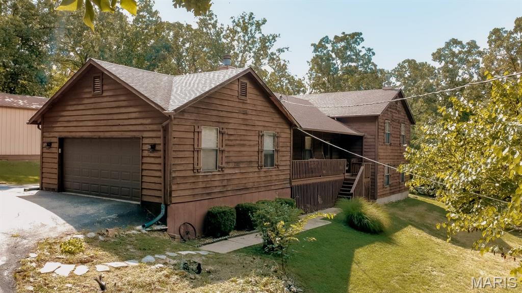 Welcome home to this spacious multi-level home nestled on a private 1.45-acre lot in Hillsboro School District! Offering 4 bedrooms, 3 full bathrooms, and plenty of room to spread out, this property combines comfortable living with the peaceful setting you've been searching for. The main level features a living room, a welcoming breakfast room, and a well-appointed kitchen complete with a large center island, ample cabinet space, and generous countertops. Perfect for entertaining! Just a half flight upstairs, you'll find the primary suite with its own full bathroom and walk in closet. Along with two additional bedrooms and a full hall bath. The lower level has a family/rec room with a walkout to the side yard and patio, creating the ideal space for gatherings, movie nights, or a game room. This level also includes the fourth bedroom, a third full bathroom, and a convenient laundry room. Another half flight down leads to the unfinished basement, offering abundant storage space.
Step outside and enjoy the privacy and peaceful surroundings this 1.45-acre property has to offer. The welcoming front porch with swing is the perfect spot to enjoy your morning coffee or unwind at the end of the day. In back, the spacious yard and patio provide plenty of room for outdoor entertaining, relaxing, gardening, or enjoying the serene setting. Car enthusiasts, hobbyists, or those needing extra storage will appreciate the oversized two-car attached garage as well as the large detached outbuilding.  New Septic 2026, New Roof 2026  If you're looking for space, privacy, and a home with room to grow, this property is one you won't want to miss!