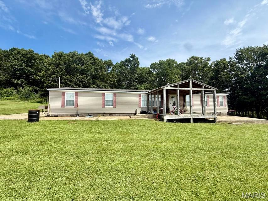 Escape to your own private retreat with this spacious 5-bedroom, 2-bath manufactured home situated on 40 beautiful acres of secluded countryside. Offering the peace and privacy you've been looking for, this property is perfect for outdoor enthusiasts, hunters, hobby farmers, or anyone wanting room to roam. The home features a functional floor plan with plenty of space for family and guests. It is move-in ready but needs new flooring in the laundry room and bathroom, giving the new owner an opportunity to add their own finishing touches and build instant equity. Outside, you'll find a 48' x 30' shop with electricity, providing ample space for equipment, vehicles, hobbies, or a workshop. The mostly wooded acreage creates excellent wildlife habitat, making this a hunter's paradise. Multiple hunting blinds are already in place, allowing you to enjoy the property from day one. Whether you're looking for a full-time residence, hunting getaway, or private country escape, this property offers the perfect combination of privacy, recreation, and opportunity. If you've been searching for acreage with a spacious home, a large shop, and excellent hunting, this is one you won't want to miss!
