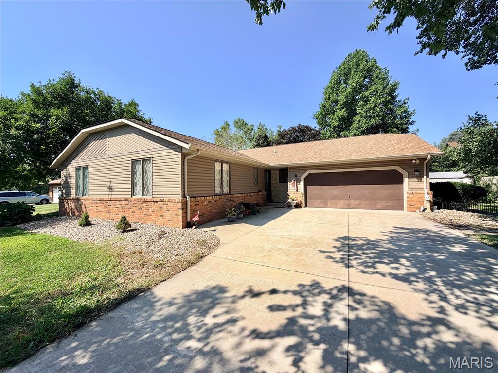 First time on the market since 1998! Located in Swansea's highly desirable Wolf Branch School District in the Rosewood subdivision, this sprawling 3-bed, 2.5-bath home offers incredible value and endless potential. The expansive main level features a massive living and formal dining room, a central kitchen connects to a cozy family room with a stove fireplace, skylight, and wet bar.  Relax in the sunroom for year-round relaxation. Downstairs, the massive lower level is an entertainer's dream, complete with a full second kitchen, expansive open space, laundry, and storage. An installed stair chairlift adds ease of mobility. Priced exceptionally well for the neighborhood, this home has fantastic bones and unmatched square footage. Bring your vision and new flooring ideas to build instant equity!