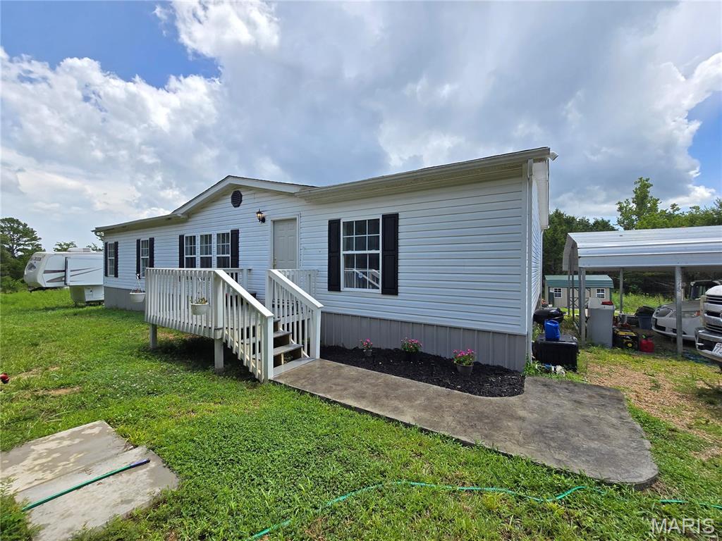 Located just a few minutes from the schools and downtown, yet just out side of main street. Your 3 bedroom, 2 full bathroom home has a newer well and septic and many updates! This beautiful home has an open floor plan with vaulted ceiling in the living room/kitchen. You will love the large primary suite featuring a double vanity, soak tub, walk in shower and large walk in closet. The kitchen has newer countertops, big beautiful windows overlooking the back yard - perfect for that sun tea or to display your beautiful array of flowers - main kitchen appliances stay as well! Relax and unwind on the front or back deck on your 3+ acres and call it a day. This home is a must see! Shed stays too!