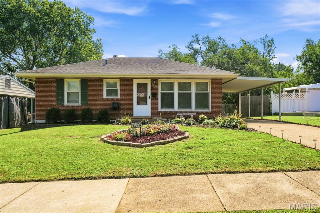 This charming bungalow is ready for new owners!  An all-brick bungalow with newer paint and flooring throughout!  Enter the home into the large living room with canned LED lighting, newer paint and carpet.  The large kitchen/dining room has newer paint on the cabinets and new laminate flooring with a white brick accent wall.  The entire main level has recessed canned LED lighting that has variable light tones and dimmable switches as well as ceiling fans in the living room and bedrooms.  The main floor offers two generously sized bedrooms with newer carpet and paint.  A main floor full bathroom rounds out the main level. The lower level is partially finished with a large recreation room, sleeping/office space and full bathroom with walk in shower.  The lower-level bathroom has been completely refreshed with new fixtures!  There is also a large laundry/storage space with built-in shelving and a newer washer and dryer that will stay with the home!  The storage area has a sump pump and radon system installed. Large fenced in mostly level back yard with patio, perfect for family fun! The refrigerator in the kitchen will also stay with the home, making this one move-in Ready!  Fresh landscape updates.
