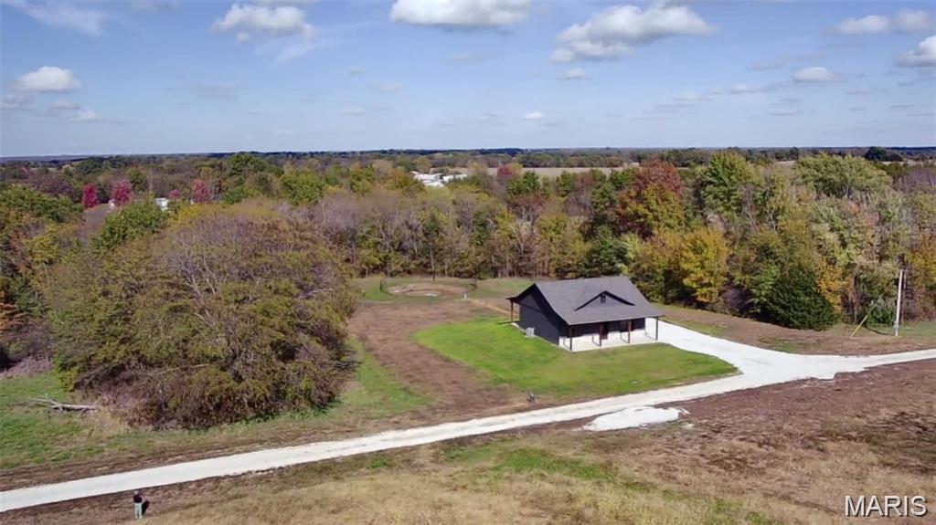 2025 built home on 5 surveyed acres not far from the Robert E. Allen Boat ramp of the Mark Twain Lake. Walking into this home you will notice the stained wood accents throughout the living room and kitchen. The living room features a floor to ceiling stone electric fireplace. The kitchen features live edge stained butcher block countertops to pair with the beautiful custom kitchen cabinets. The  stainless steel kitchen appliances will convey with the sale. Doing laundry has been made easier in this home with a full walk-in laundry room complete with storage and countertop space. This home provides 2 bedrooms and 2 full baths. The master suite has a full walk-in closet and a master bath that features a custom onyx shower. Bedroom number 2 has a decent size closet and is located right across the hall from the 2nd full bath.  This home is wrapped in LP Smart siding which, not only looks good, but is very durable. We can't forget about the covered front and back porches that feature stained cedar post and beam work. Each porch (front and back) provide 2 ceiling fans to keep some air moving on those hotter days. This place seems very secluded for being less than a mile from highway 154! The yard has been professionally hydroseeded last year. There is 5 additional surveyed acres that could be bought as well!