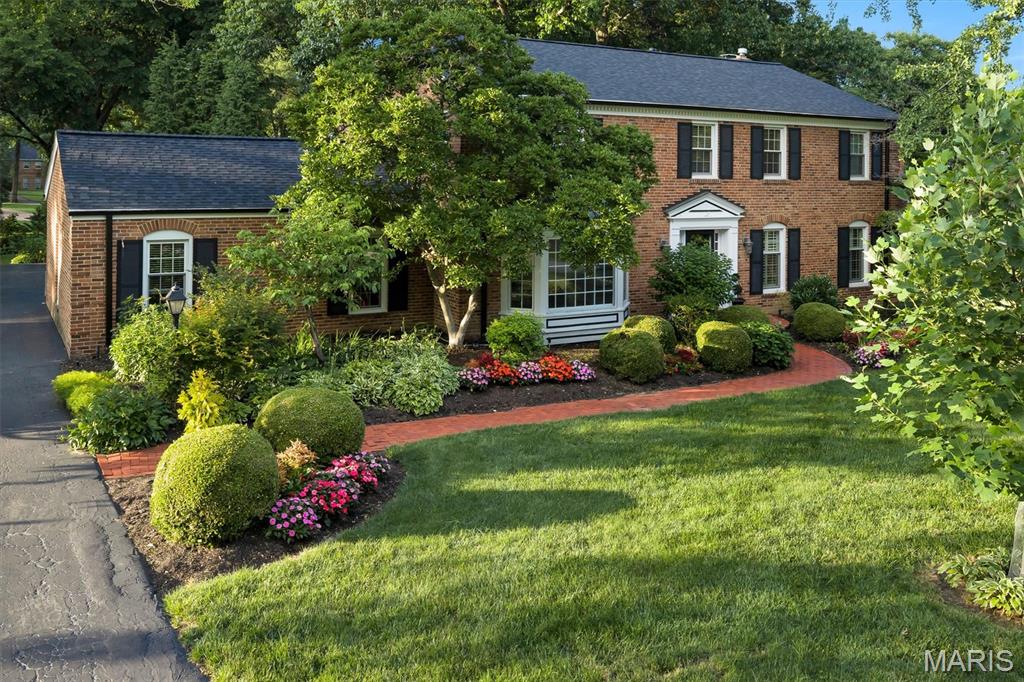 Nestled on a spectacular tree lined lot in Ladue, this beautifully renovated 4 bed, 4.5 bath home offers luxury living both inside and out. The chef’s kitchen features custom cabinetry, granite countertops, a Wolf range and double oven, Sub-Zero refrigerator, and oversized center island. A dramatic vaulted dining and gathering space with skylights and walls of windows fills the home with natural light and overlooks the private backyard retreat. Designed for entertaining, the home also features a custom bar area, spacious family room with fireplace, and a finished lower level with a custom wine cellar. The upper level includes a luxurious primary suite with a spa inspired bath and custom walk-in closet, a private bedroom suite with en-suite bath, and two additional bedrooms served by an updated hall bath. Outside, enjoy a resort-style in ground pool, expansive patio, and lush landscaping surrounded by mature trees. Exceptional indoor and outdoor living in a premier Ladue setting.