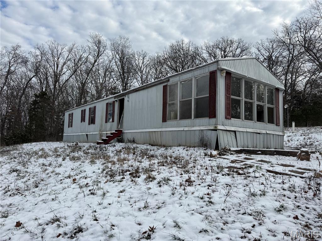 Looking for a project with BIG potential? This 3-acre property just outside town offers the perfect blend of privacy, convenience, and opportunity. Whether you're dreaming of a quiet homestead, a weekend getaway spot, or an investment remodel, this parcel is ready for your vision. Water, sewer and electric are set up.