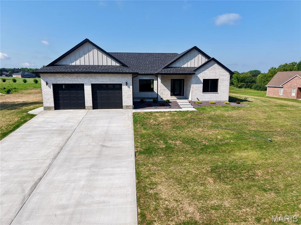 New construction offering 3 bedrooms, 2 baths, and 2,020 sq ft of thoughtfully designed main-level living. The open-concept floor plan flows easily from room to room, with oversized windows framing views of Hole 3 at Norwoods Golf Course and filling the space with natural light. A split bedroom design places the primary suite privately apart from the two additional bedrooms, complete with a large walk-in closet and a stunning bath featuring a soaking tub and separate shower. Dual heat sources provide year-round efficiency and comfort. The full brick exterior means lasting durability with minimal upkeep, and the landscaping is already complete. Downstairs, 2,020 sq ft of unfinished basement is ready for your vision, with two egress windows already in place for future bedrooms — room to nearly double your finished square footage. New build quality, golf course views, and room to grow. Schedule your showing today.