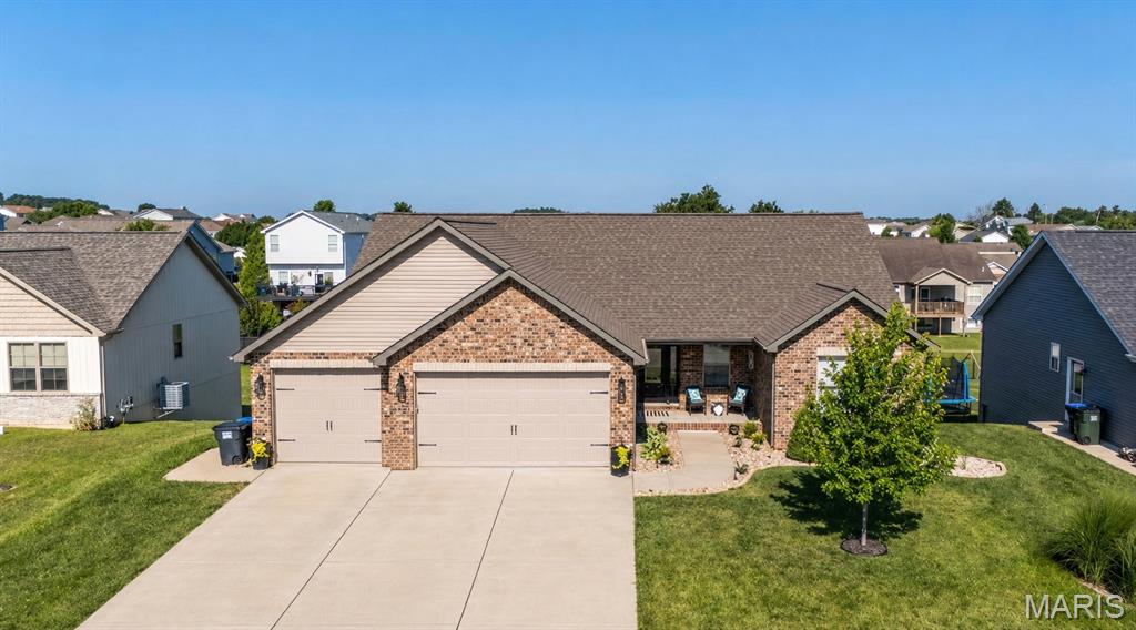 Welcome home to this beautiful brick ranch in the Remington Ridge neighborhood! From the covered front porch to the fenced backyard and covered deck, this home is move in ready! 

Step inside to an open floor plan featuring CoreTec luxury vinyl plank flooring throughout the main living areas, a beautiful stone fireplace, and a spacious living room that flows seamlessly into the eat-in kitchen. The kitchen offers cotton white cabinetry with a pewter glaze, granite countertops with a lifetime seal, a center island, pantry, and stainless steel appliances.

The main level includes two secondary bedrooms, a full bathroom, and a spacious primary suite with double doors, a walk-in closet, and a private bath featuring a double vanity.

The finished walkout basement provides even more living space with a large family room, an additional bedroom, and a full bathroom. The walkout leads to a covered patio below the covered deck, creating two great outdoor spaces to relax or entertain, all overlooking the fenced backyard.

Additional features include an oversized 3-car garage with 8-foot doors and 25-foot-deep bays, plus 9-foot basement ceilings that make the lower level feel bright and open.

Built in 2021, this move-in ready home offers modern finishes, plenty of space, and an excellent location in the sought-after Remington Ridge neighborhood. Don't miss your chance to make it yours!