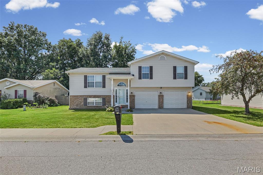 Welcome Home to this 4bd 2bath home with large 2 car garage. Enter the split-level foyer that leads upstairs to the recently updated large living and eat in kitchen areas. The kitchen offers ample cabinet space and a large island with gorgeous Quartz countertops and newer stainless appliances and a sliding glass door that leads to the large deck. The open living area offers a beautiful brick gas fireplace for cozy winter nights. Head up to the upper level where you will find the primary bedroom with walk in closet and primary bathroom with ceramic tile and walk in shower with rainfall shower head. Rounding out the upper level are 2 more bedrooms and main bathroom. Head back down to the lower level to find the 4th bedroom with newer carpet and a large storage area.