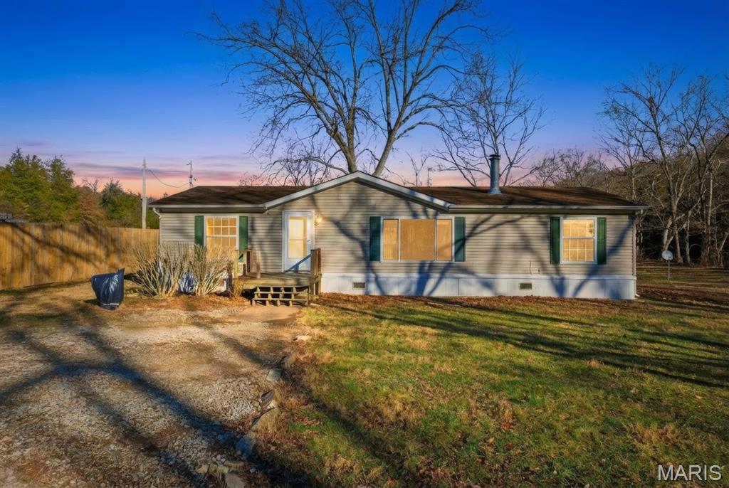 Tucked away on 5.4 private acres, this rural retreat offers the rare combination of peace, freedom, and convenience—just minutes from I-55, yet far enough away from the city noise.

The land itself is the star: a beautiful mix of open field, mature woods, and a winding creek, with flat, usable ground ready for whatever vision you have. Build a detached garage, expand parking, create outdoor entertaining spaces, start a hobby farm, or simply enjoy wide-open space with no HOA and no restrictions telling you what you can or can’t do.

Inside, the home is warm, inviting, and thoughtfully laid out. Vaulted ceilings and an open-concept floor plan create an easy flow for everyday living and hosting alike. The spacious kitchen features abundant cabinetry, a wrap-around island perfect for gathering, and a pantry, making it as functional as it is welcoming.

The living room is anchored by an oversized window that brings the outdoors in and a cozy wood-burning fireplace—a perfect setting for quiet evenings or weekend get-togethers.

The primary suite is generously sized and designed for comfort, offering a large walk-in closet and a private bath with double vanities, a separate shower, and soaking tub.

Recent updates include new front windows and some new flooring throughout, with the roof and furnace recently serviced and well maintained. To give buyers flexibility and creative freedom, a $5,000 credit is being offered at closing—ideal for finishing remaining flooring or adding personal touches to truly make the home your own.

This is a property that invites you to slow down, spread out, and build something meaningful—whether that’s space for projects, animals, entertaining, or simply room to breathe.

Homes with this much land, privacy, proximity, and price don’t come around often. This one is ready for its next chapter!