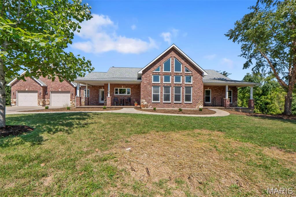 Impressive from the inside out! This completely custom 5-bedroom, 3.5-bath home offers an incredible combination of space, upgrades, and unique finishes, all situated on nearly 14 acres. Step inside and you’ll immediately notice the stunning cathedral-style ceilings featuring custom beams and beautiful woodwork. The main level offers hardwood flooring throughout and a spacious kitchen with ample cabinet and counter space, along with a large center island complete with a washing station and trash compactor. Three bedrooms, all offering walk in closets, are located on one side of the home, along with a full bathroom and full laundry room. The main level also features a large family room with a wood-burning fireplace & a spacious dining area perfect for large family gatherings or entertaining. On the opposite side of the home, you’ll find a breakfast area, office space, and an impressive primary suite. The primary bathroom features a large walk-in shower, jetted tub, double vanities, and two walk-in closets. A second large laundry room adds even more convenience to this thoughtfully designed home. The lower level provides even more room to spread out with an additional family room featuring a wood stove, a media room, and a recreational room with walk-out access to the in-ground pool. This level also includes a large bedroom, full bathroom, and a safe room for added peace of mind during stormy nights. If all of the interior extras aren’t enough to impress, step outside and enjoy everything this property has to offer. Take a dip in the in-ground saltwater pool, relax and enjoy the peaceful surroundings, or wet a line in the fully stocked pond. The property also features a large barn with plenty of space for storing utility vehicles, lawn equipment, and more. With nearly 14 acres, incredible indoor and outdoor entertaining spaces, a saltwater pool, stocked pond, newer barn, and an abundance of thoughtful upgrades, this property offers a truly unique opportunity to enjoy the space, privacy, and amenities you’ve been looking for.