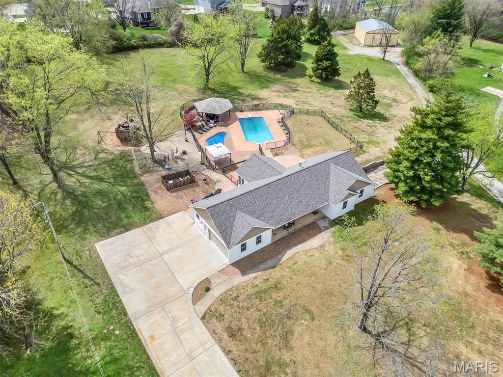Rare opportunity to own THREE ACRES in St, Charles County so close to Highways and Shopping Yet TUCKED away in a PRIVATE HAVEN!  Newly remodeled 4 bedroom RANCH home, 3000 sq ft of living area, 3 full baths, 1 half bath, 2 car finished garage.  Updates include: kitchen, off white shaker cabinets, granite counter tops, stainless steel appliances,  Kitchen refrigerator is negotiable. Luxury vinyl plank flooring,  lighting, six panel doors, 6 inch trim, blinds, furnace,  air conditioner, trusses, architectural shingle roof, siding, soffits, fascia, gutters, downspouts, windows, electrical, and more.  Home has been freshly painted. 

Additional Features include:  KITCHEN has lots of counter space, built in microwave, double oven in the range, smooth top stove and more.  Vaulted GREATROOM, wood burning fireplace with brick surround, BONUS ROOM with 12 windows and 2 exit doors, recessed lighting, Wood window sills and apron. Main floor laundry.  PRIMARY BEDROOM with luxury bath, walk in closet, barn door entries, center light and fan.  Secondary bedrooms both are generous size, luxury vinyl plank floors, center lights and fans. Primary Bathroom and Hall bath both have tiled floors,  large vanities, new lights, and large linen closet. 

 FINISHED LOWER LEVEL is great for additional living quarters with rec room, bedroom, and full bath. Lower Level walks out to the side yard. 

GARAGE is finished, insulated, drywalled, epoxy painted floors, pull down stairs to access the attic for storage. Garage has been freshly painted.  New insulated garage door and opener. 

Oasis in the back yard includes inground saltwater POOL, inground SPA, gazebo, stamped concrete patio surround, black aluminum fencing.  

Outbuilding is 40x60 pole barn with 14 foot clearance, concrete floors, electrical service, and its own driveway. 

Great Location and Home!  Be sure to check it out!