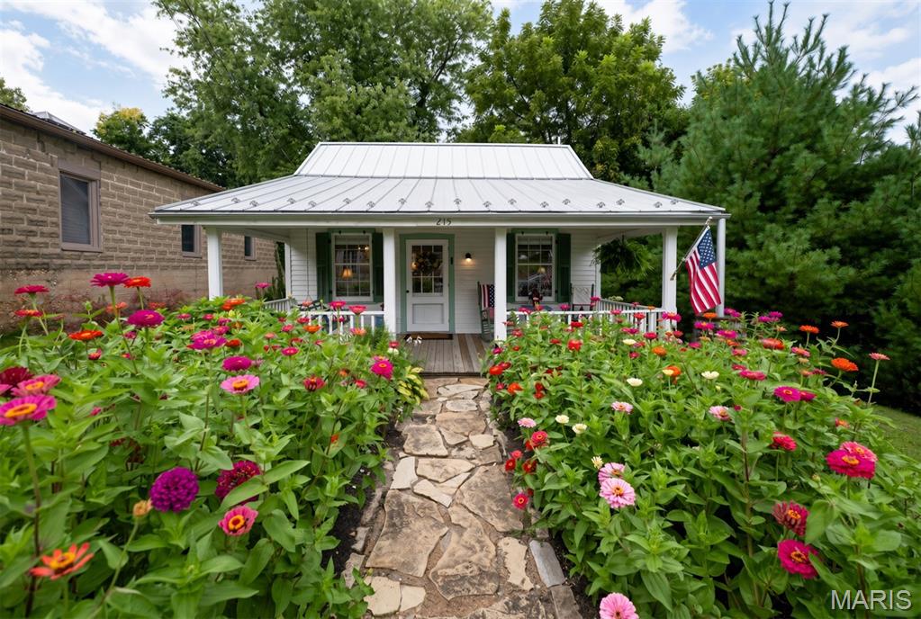 Welcome to this beautifully restored 1800s cottage in historic Augusta, Missouri—the gateway to wine country! This is your once in a lifetime opportunity to invest in America's first official 'American Viticultural Area' (AVA). Augusta, Missouri is enriched with history and centuries of settlers like Daniel Boone. 
This quaint 1-bedroom, 1-bathroom gem boasts a remarkable history and rich historic craftsmanship. Currently thriving as an active, successful short-term rental, this property offers incredible versatility. 
Whether you are looking for a turnkey investment property or a peaceful personal getaway, this unique piece of Augusta history is ready for its next chapter. 
A Rich Historical Legacy saved from Destruction: Originally built in the Missouri River Bottoms,just southeast of Augusta, a portion of this historic home was rescued around 1960 by Darold Rhinedollar.  Mr. Rhinedollar, the town's last local blacksmith, carefully moved the structure to its current site next to his historic operational livery building, which still stands today. A historical architect notes that the home's original glass windows likely date back to the 1700s and were brought to the area by boat via the Missouri River. The current owners had custom storm windows made to protect and preserve these windows. 
Over the decades, this resilient building served as a beloved antique shop before being lovingly transformed into a successful Bed & Breakfast in 1998. In 2020 the home had renovations and new standing seam roof along with the timeless half round gutters. The current sellers at this point decided they would share their love for The Cottage with others and create a short term rental. 
Thanks to Mr. Rhinedollar's exceptional care during the relocation, combined with modern updates and meticulous ongoing maintenance, this solid little house is structurally sound and built to last another 100 years. 
Schedule your visit and experience the unmatched tranquility of wine country living. Call for your private tour today to witness this historic masterpiece in person!