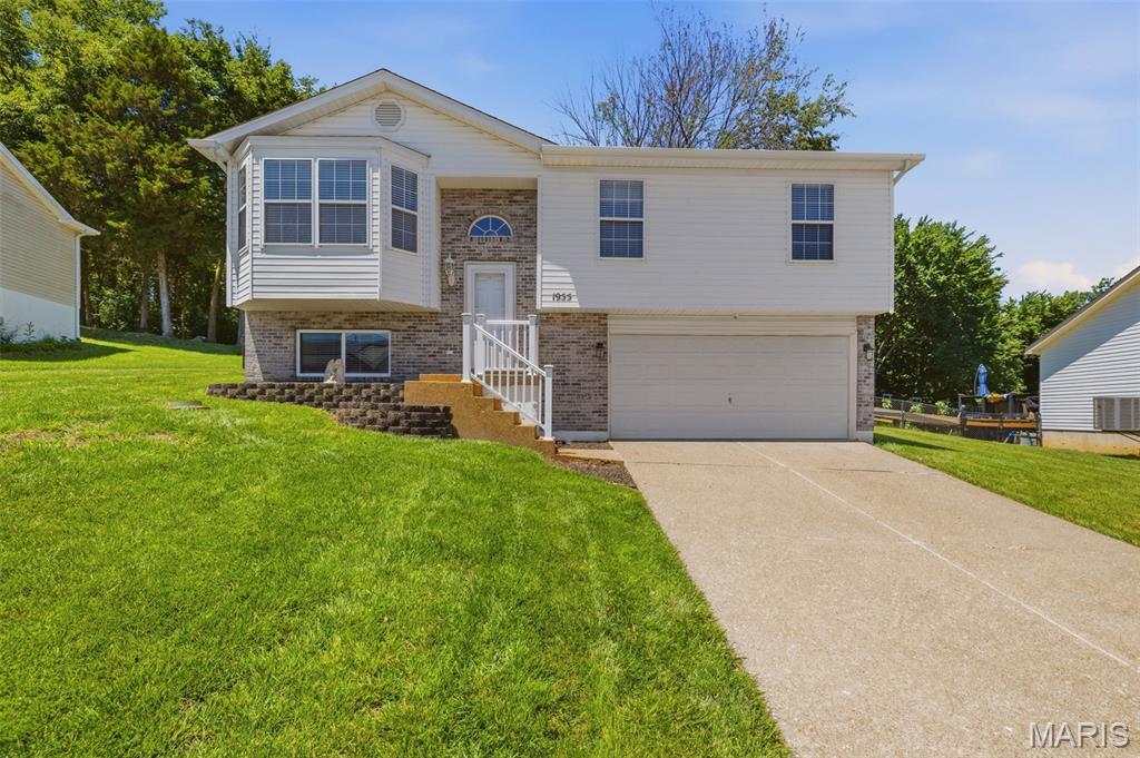 Backyard space, vaulted ceilings, and a finished walk-out lower level—this Festus beauty offers the room to live, entertain, and grow on one of the larger lots in the neighborhood. Welcome home to this beautifully maintained 3-bedroom, 3-bath home tucked away in the desirable Northwoods subdivision of Festus. Situated on an oversized .39-acre lot, backing to lush woods, this move-in-ready home offers the space, updates, and backyard privacy that today's buyers are searching for. Step inside to find a bright, open main level filled with natural light, soaring vaulted ceilings, and a comfortable layout designed for everyday living. The spacious living room flows seamlessly into the eat-in kitchen, featuring ample cabinetry, generous counter space, and easy access to the composite deck—perfect for morning coffee, grilling, or entertaining friends and family. The main floor also includes three generously sized bedrooms, including a private primary suite with its own full bath. The finished walk-out lower level expands your living space with a large family room, a third full bathroom, and flexible space ideal for a home office, playroom, media room, workout area, or guest retreat. Whether you're hosting game day gatherings or simply need room to spread out, this lower level delivers. Outside, you'll love the oversized fenced backyard surrounded by mature trees, creating a peaceful setting rarely found in subdivision living. The large deck overlooks the backyard and offers plenty of space for outdoor dining, summer barbecues, or simply relaxing while enjoying the view. Additional highlights include a 2-car attached garage, 2-car concrete driveway, low-maintenance vinyl siding, updated flooring and finishes, and a minimal HOA of just $75 per year. Located in the highly rated Festus R-VI School District and just minutes from shopping, dining, parks, and highway access, this home combines small-town charm with everyday convenience. If you've been looking for a home with extra space, a large yard, and a move-in-ready feel, this is one you won't want to miss. Showings begin Friday 06/19/2026. We are requesting a minimum of a 48 hour response time on all offers. Thank you!