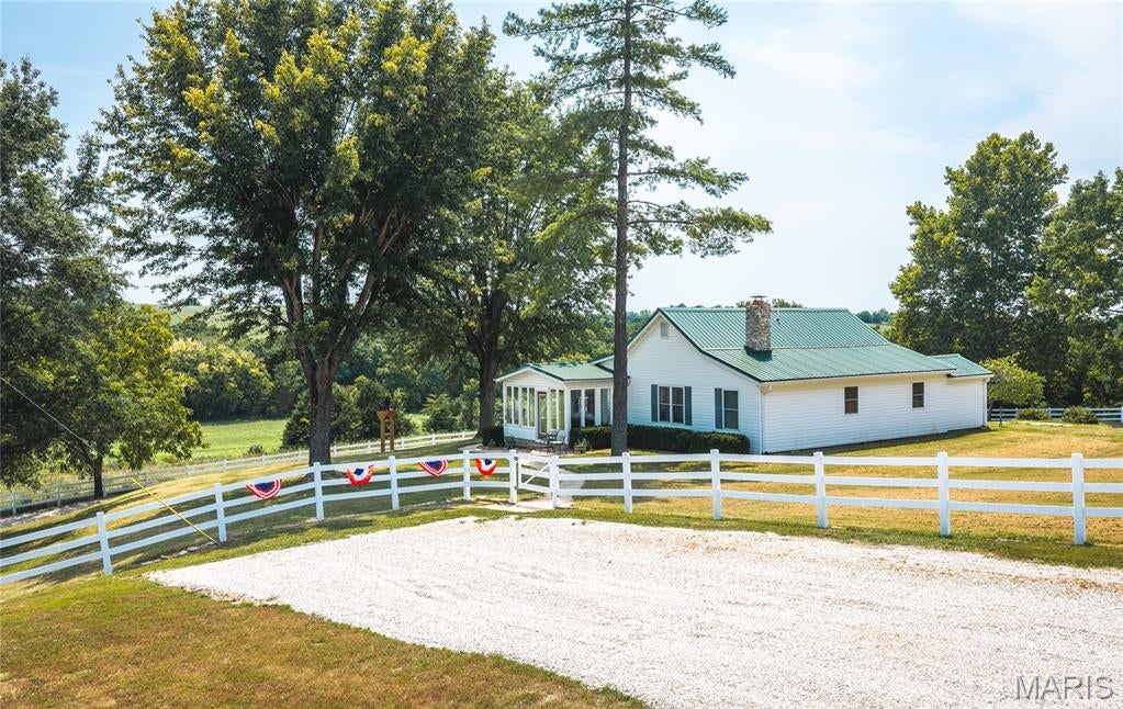 Exceptional turnkey farm offering 199 M/L acres of rolling pasture and woods, breathtaking panoramic views, and everything you've been searching for! This remarkable property is thoughtfully designed for both livestock production and country living, featuring 10 ponds, including a stunning 4-acre stocked lake, automatic waterers, and fenced and cross-fenced pastures ready for your operation. The beautifully renovated 1,850 M/L sq. ft. home has been updated from top to bottom and offers quality finishes throughout. Featuring 3 bedrooms, 2 full bathrooms, a spacious living room, large family room, inviting sunroom, and an open kitchen and dining area, this home provides the perfect blend of modern comfort and rural charm. Every detail has been carefully updated, allowing you to move in and immediately enjoy the property. Outside, you'll appreciate the oversized 2-car attached garage, large detached barn, and the exceptional infrastructure that makes this farm truly turnkey. Whether you're expanding your cattle operation, starting a hobby farm, investing in quality farmland, or simply looking for a private country retreat with incredible scenery, this property offers endless possibilities. Rarely does a farm of this caliber become available. From the stunning views and abundant water sources to the beautifully renovated home and ready-to-use improvements, this is a one-of-a-kind opportunity. Schedule your private tour today and experience everything this extraordinary farm has to offer!